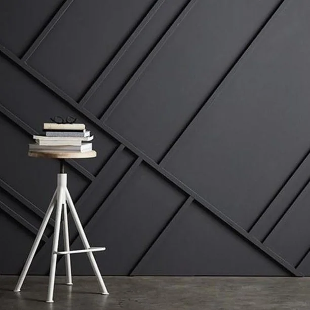Turn a boring blank wall into a unique and fascinating home feature by adding an eye-catching woos strip patterns. This otherwise sombre black wall is made exceptional by the addition of randomly slanted wood strips. 
#RenoGuide #DIY #InteriorDesign #Black #FeatureWall #DesignInspo #Inspo #Minimalist