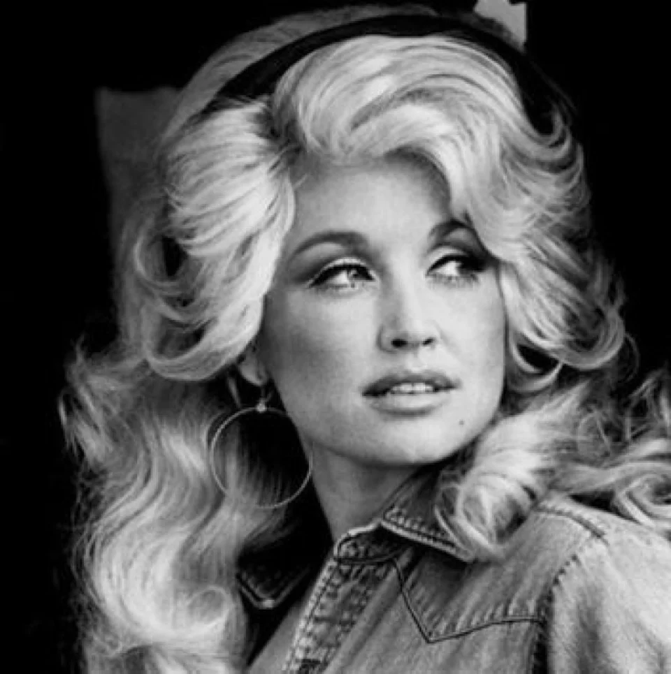Dolly! Cara loves this brilliant philosopher, spiritual guide, guru, and spitfire. She's a wise, old soul who has decided to emerge from her cave-dwelling meditation, throw on some pink lipstick, and sing from the heart to show the world that vulnerability and strength are both the same thing. 