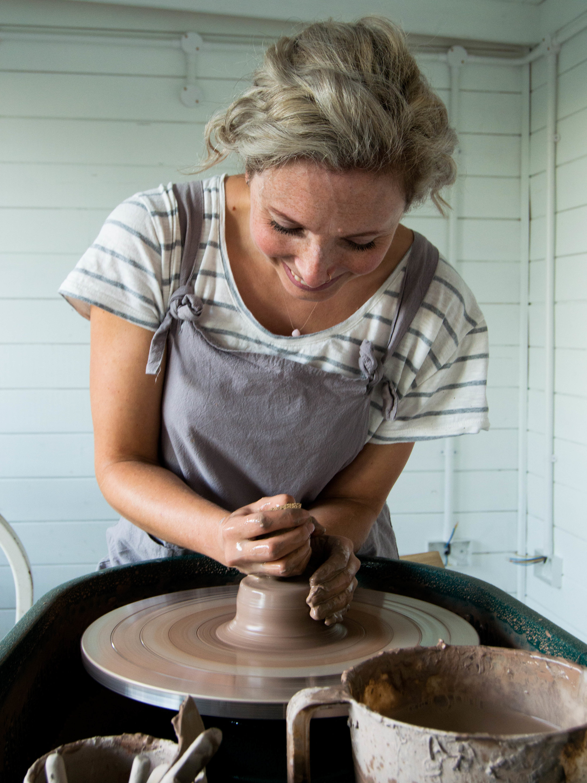 Potter at work at his pottery wheel 