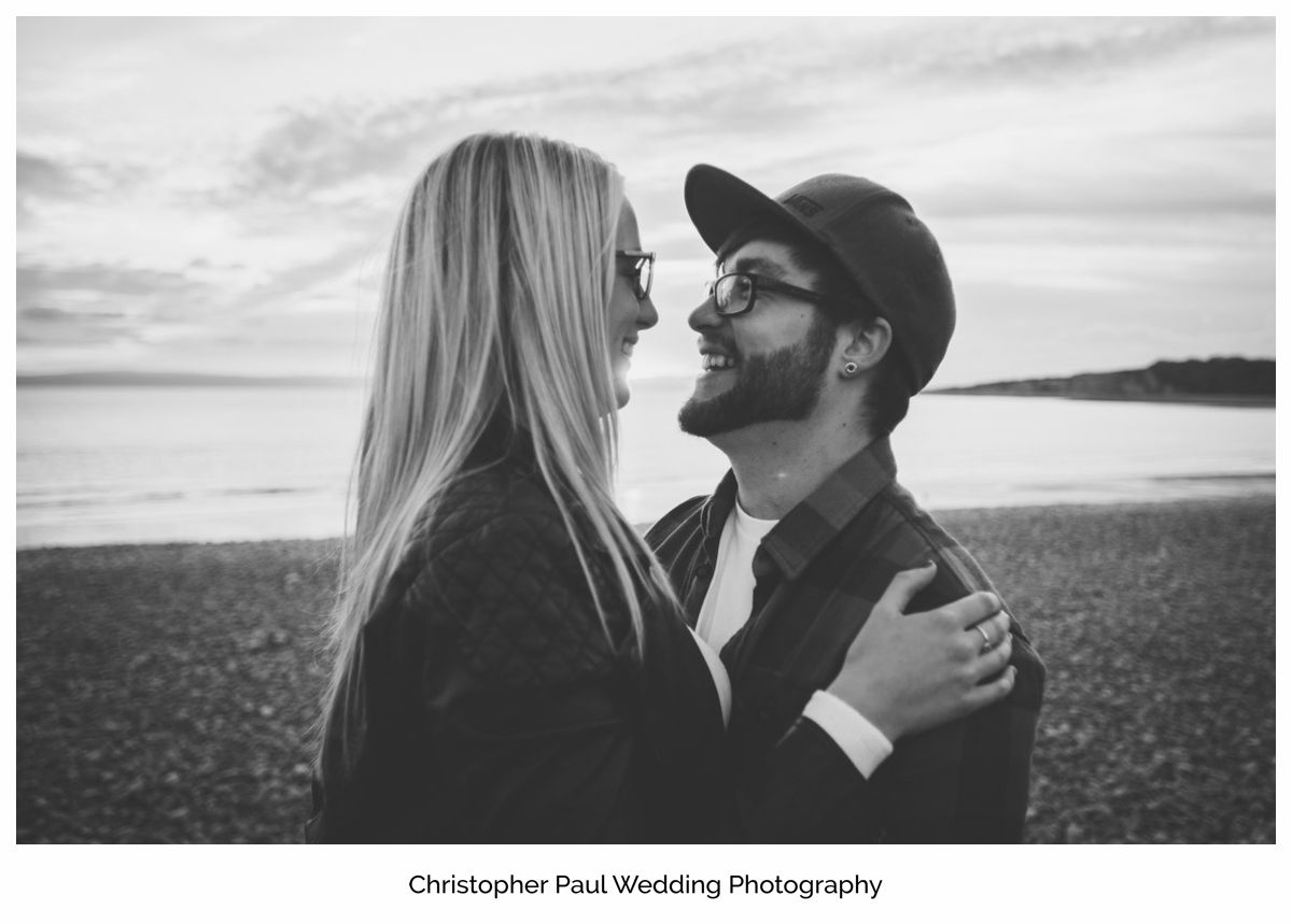 A beautiful engagement photo with the Barry Sunset behind, Cardiff Wedding Photographers