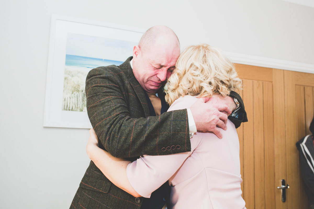 An emotional father of the Bride crying with joy