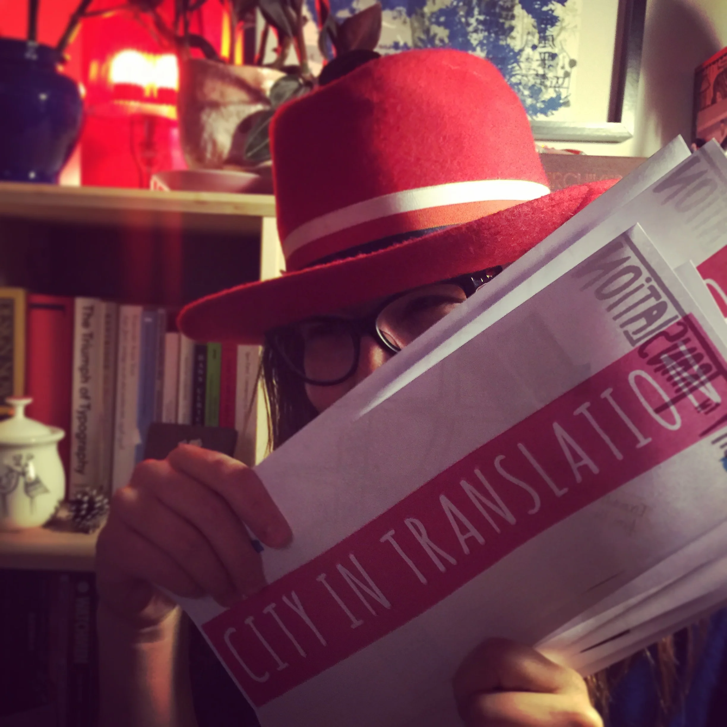 Ready to hit the road! (that's me in my Amsterdam home, holding my DIY maps which I tell you more about later in this post)