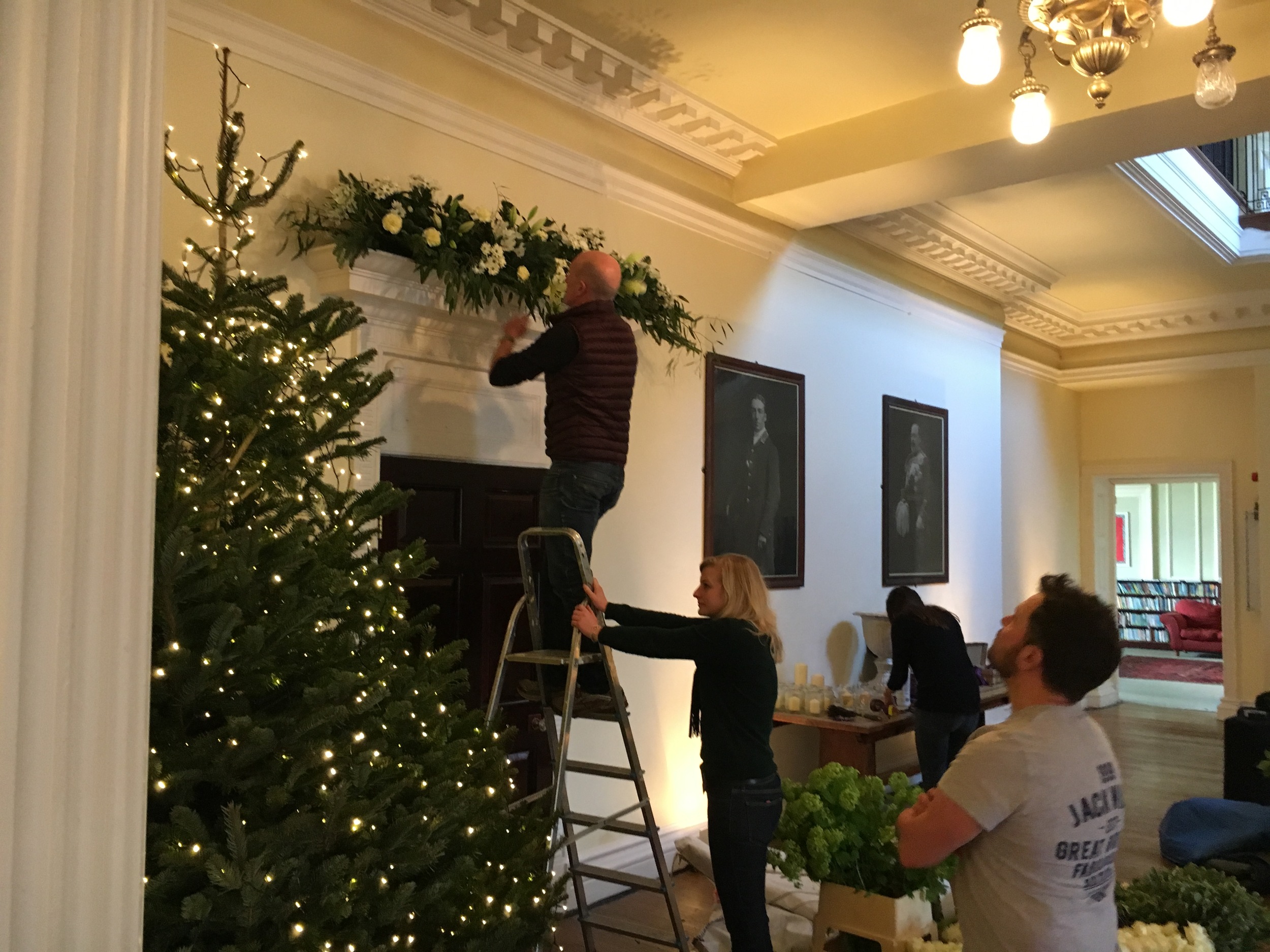Andy, Eleanor and Paul work on the giant pediment designs above the elegant doors.