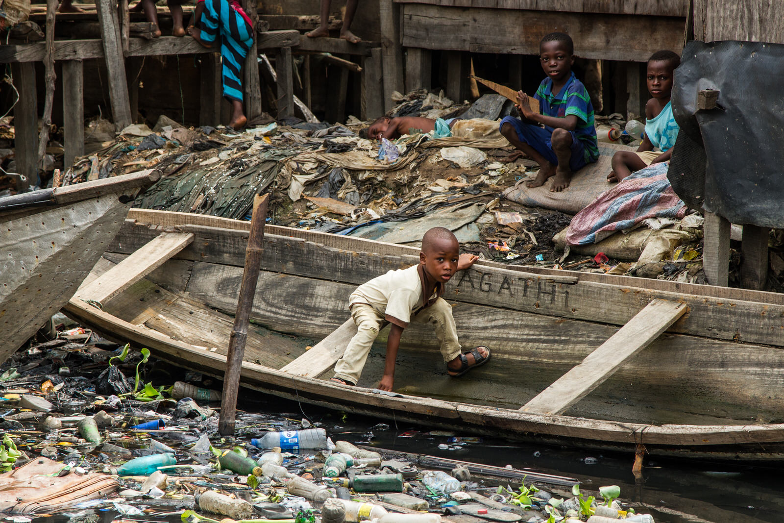 Rubbish litters the waterways where children play and families live. Much of the rubbish is collected an used as an innovative foundation for land reclamation.