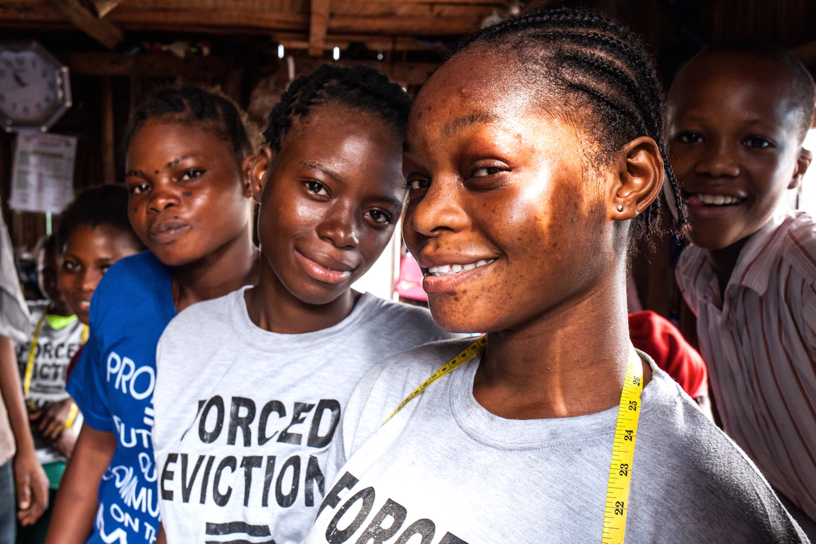 Gerard teaches tailoring to a number of young apprentices.