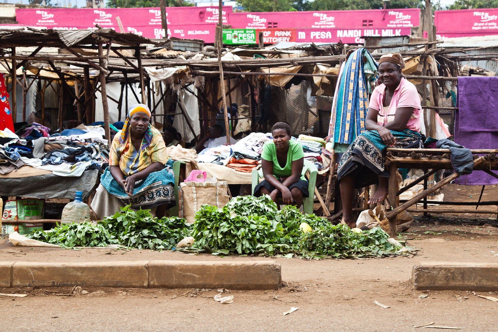 Anna (right) is a farmer who comes to sell her produce at Kondele where she has been selling vegetables for 10 years. If she could trade anywhere she would trade at Jubilee where she could sell her products for double.