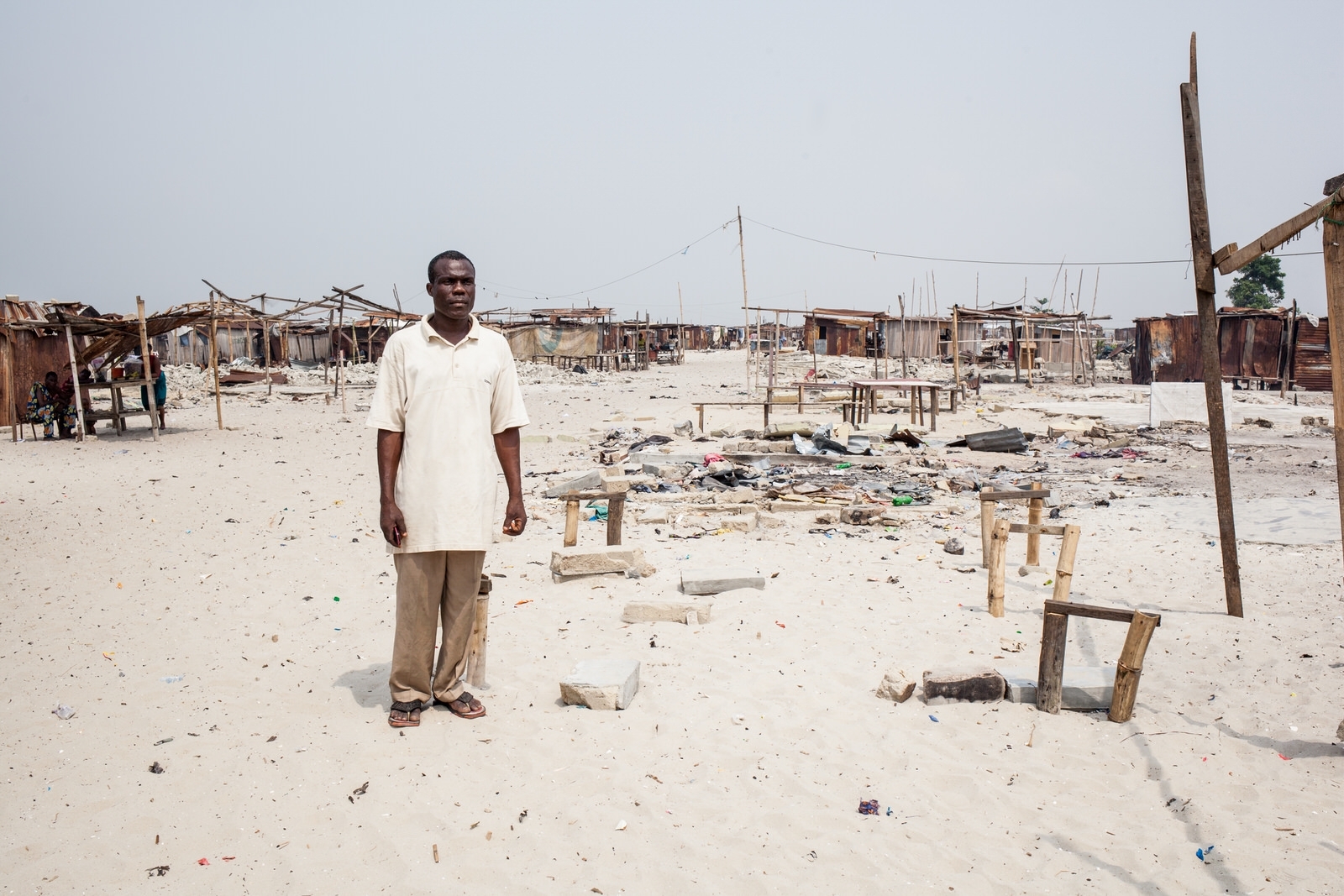  Pascal Torshun, a fisherman and Otodo Gbame elder stands amongst the remnants of a church. Pascal sold drinking water, and is an active community member. 