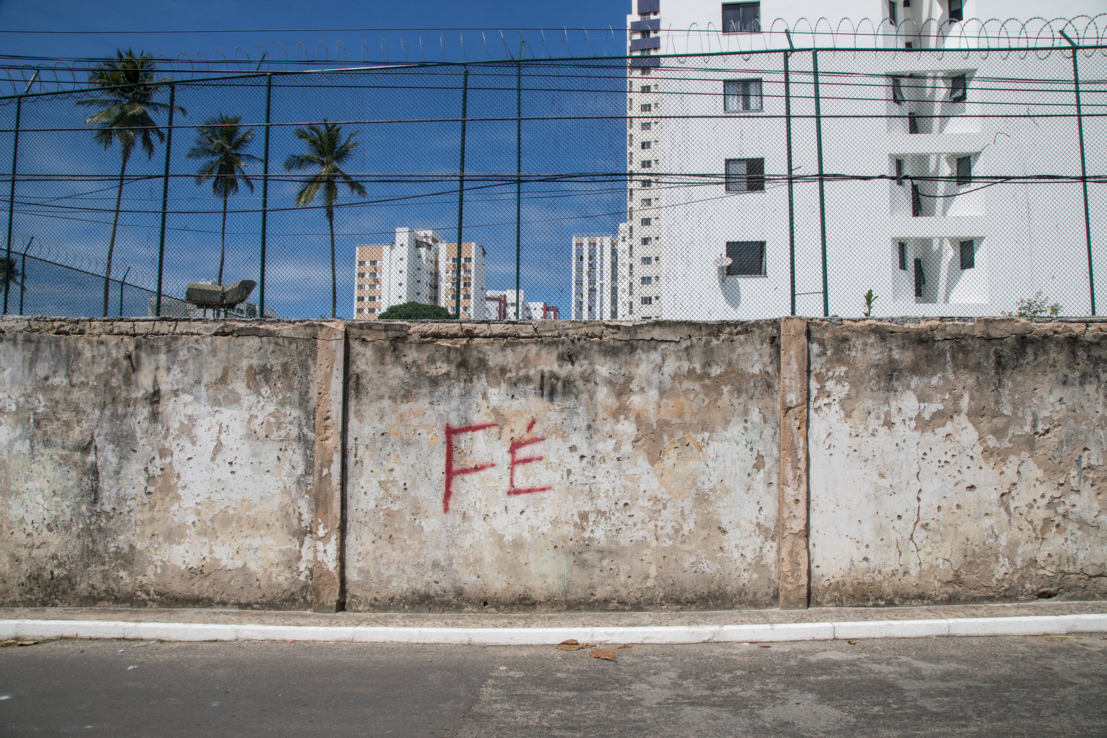  The word ‘Faith’ is written on a wall on the Nordeste de Amarelina side of a wall that divides two communities of Salvador residents, the rich and the poor. The wall is a product of fear. 