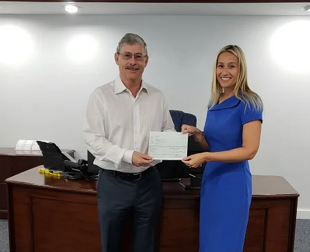 IPCA representative and Essay Competition Judge, Sophie Peat, presents the runner-up cheque to Coilin’s father, Sean Flynn, in Coilin’s absence.