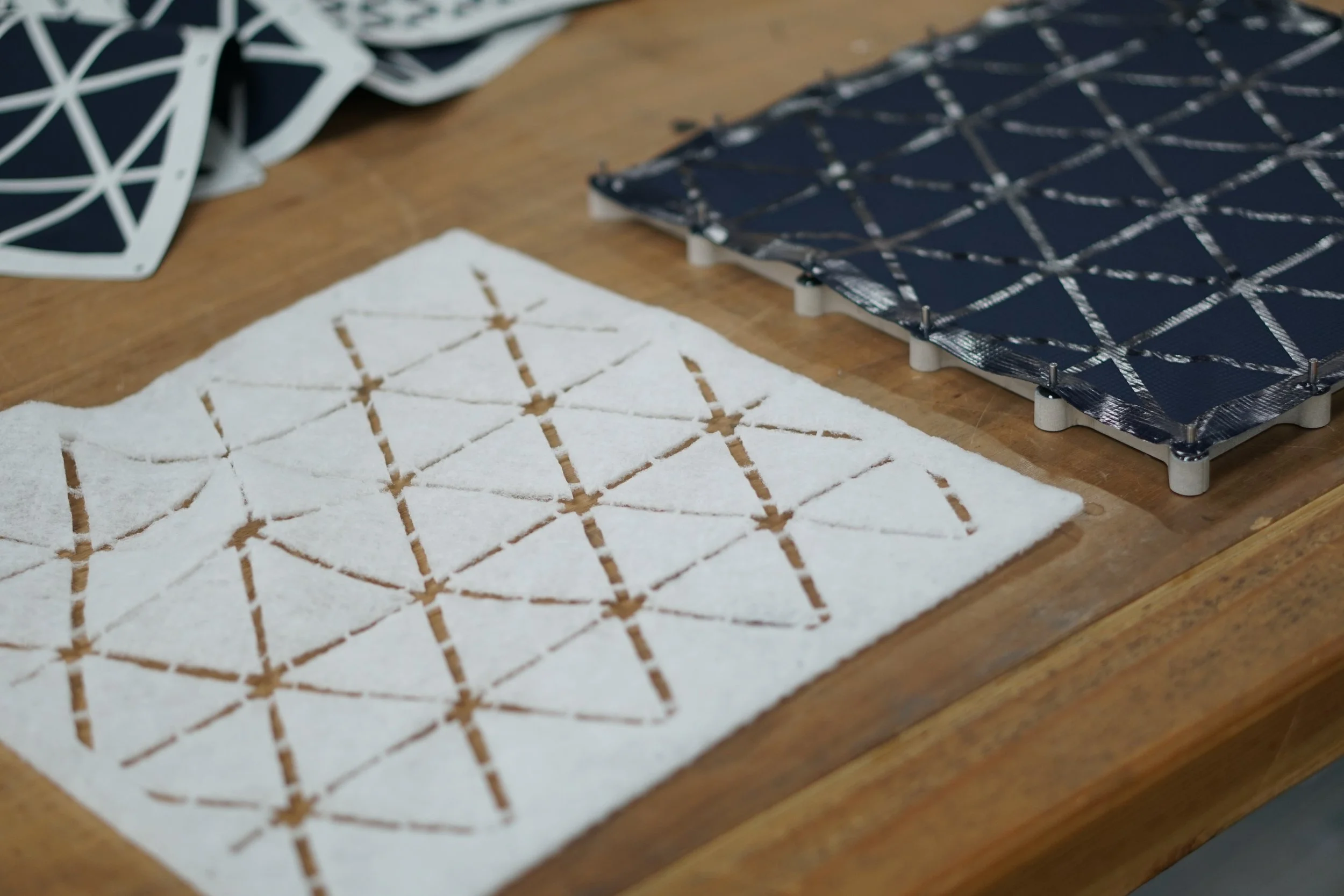 Tooling used to align adhesive, textiles, and insulation