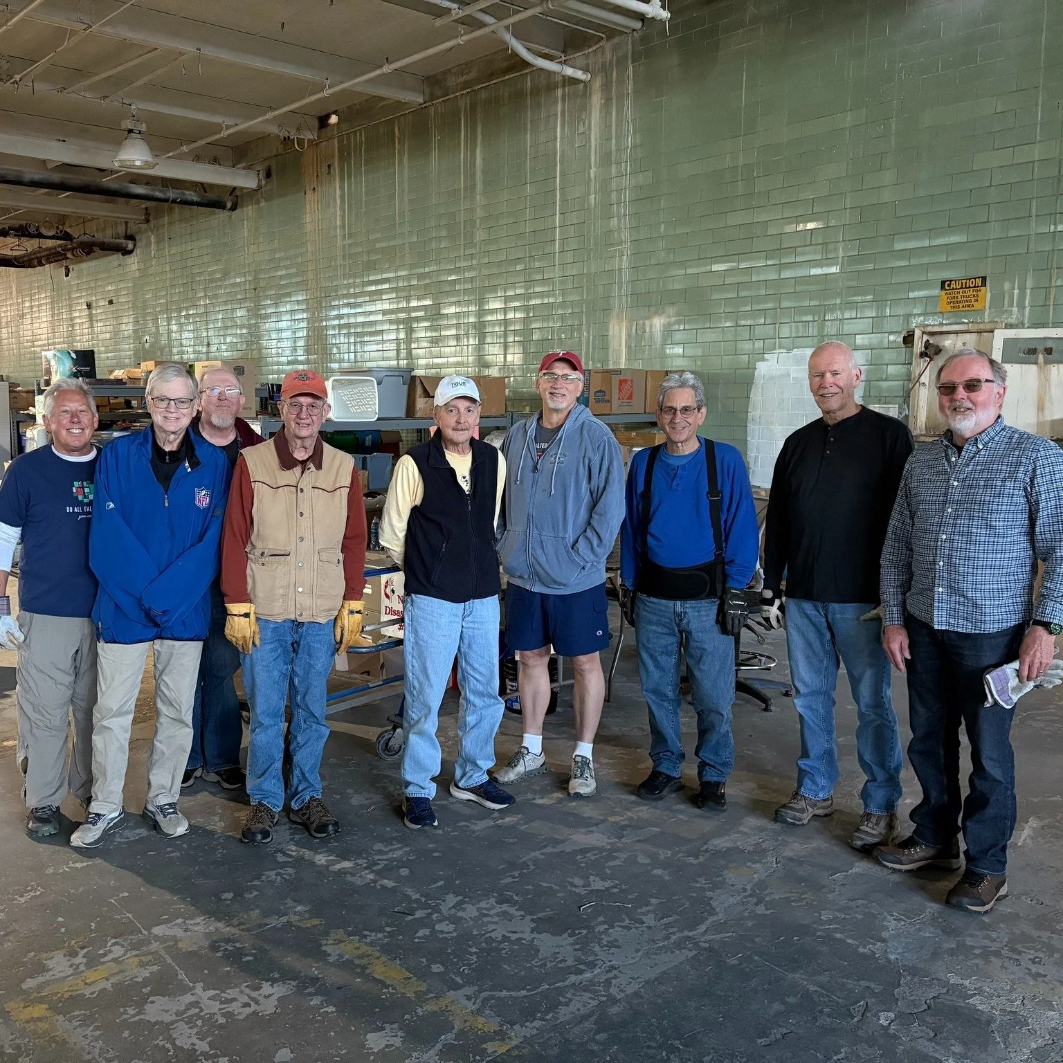 Nine men volunteered to return to the North Georgia Disaster Response warehouse at Impact Church in East Point on Saturday, October 25.  In July, warehouse roof repairs required moving all supplies and shelving. Repairs completed, everything needed t
