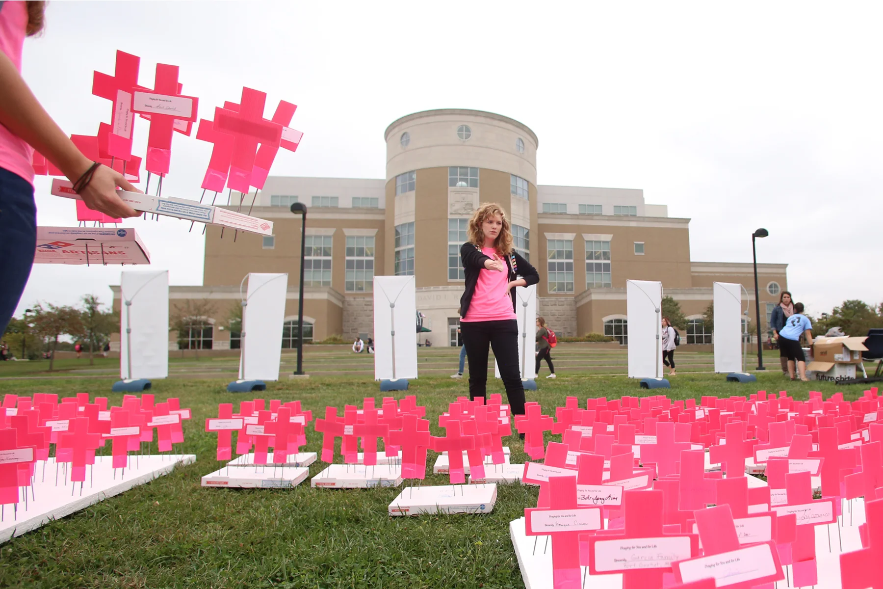 Sarah Martin, a freshman psychology major, directs the movement of crosses stuck into pizza boxes while setting up the Planned Parenthood Project, a Students for Life organized display that was shown in the Quad Wednesday. The display consisted of 897 crosses symbolizing the number of abortions they say Planned Parenthood has a day. (Shot for The Shield)