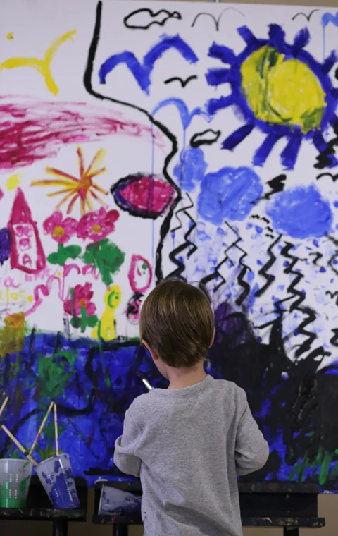 Two-year-old Dax Chevalier paints his part on a canvas open to children at the Global Crossroads culture and music festival in New Harmony Saturday. (Shot for The Shield)