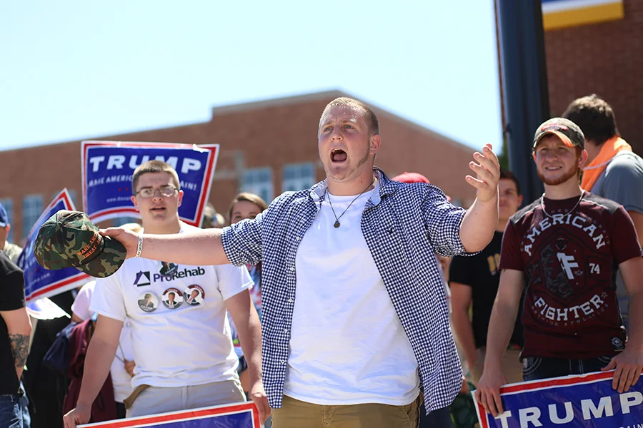 A student from Boonville High School Jon Pearl, 18, yells over at the protesters as each side argues back and forth following the Trump rally Thursday. (Shot for The Shield)