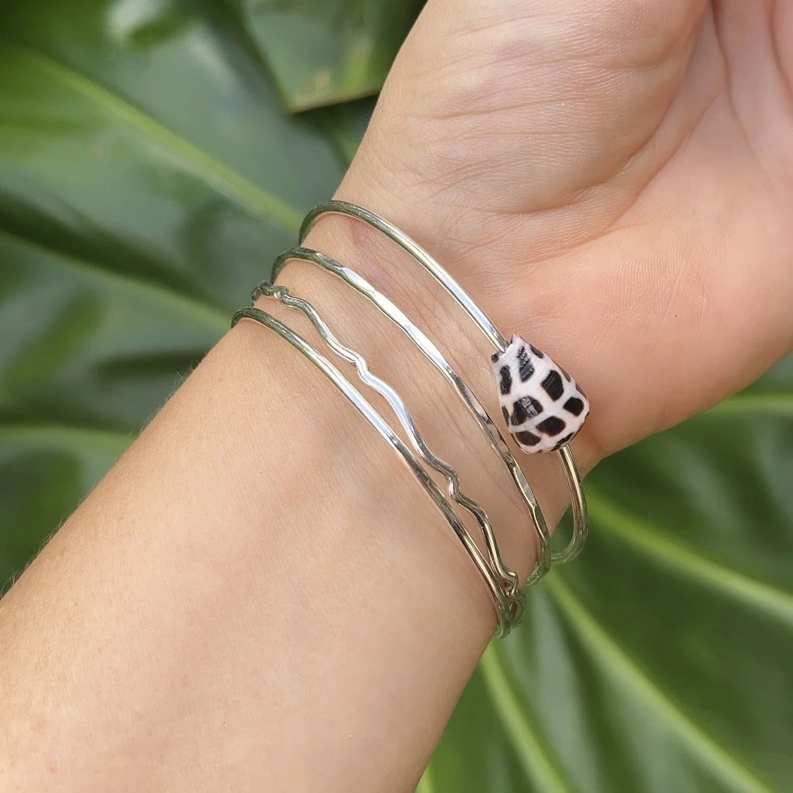 Handmade seashell bangle in sterling silver, one of the designs students can create in a Big Island jewelry making workshop