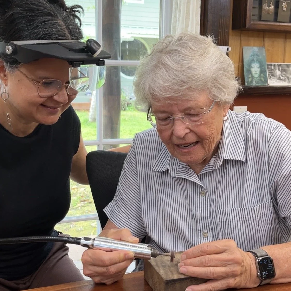 Private jewelry making class near Hilo, Hawaii with instructor guiding a student in a silversmith studio on the Big Island
