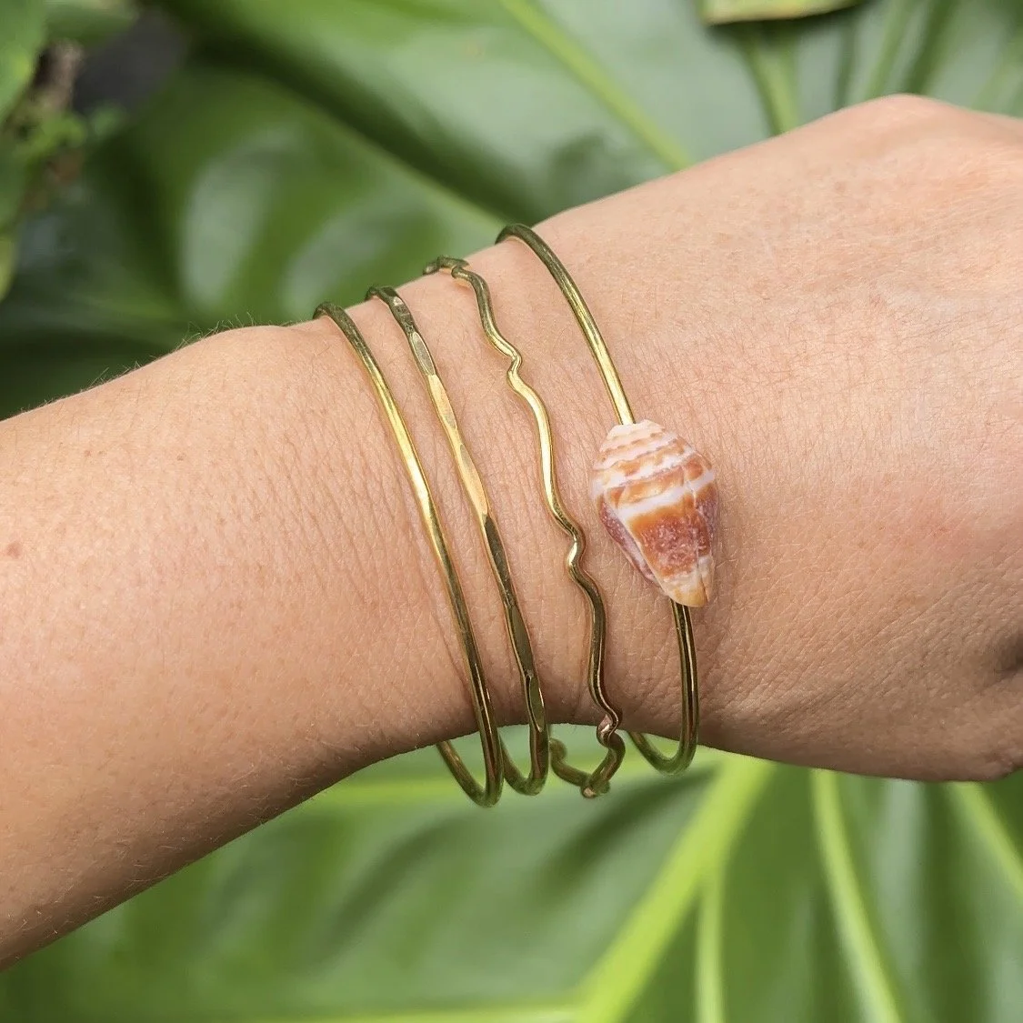Brass seashell and textured bangles handmade during a beginner-friendly jewelry making class on the Big Island of Hawaiʻi