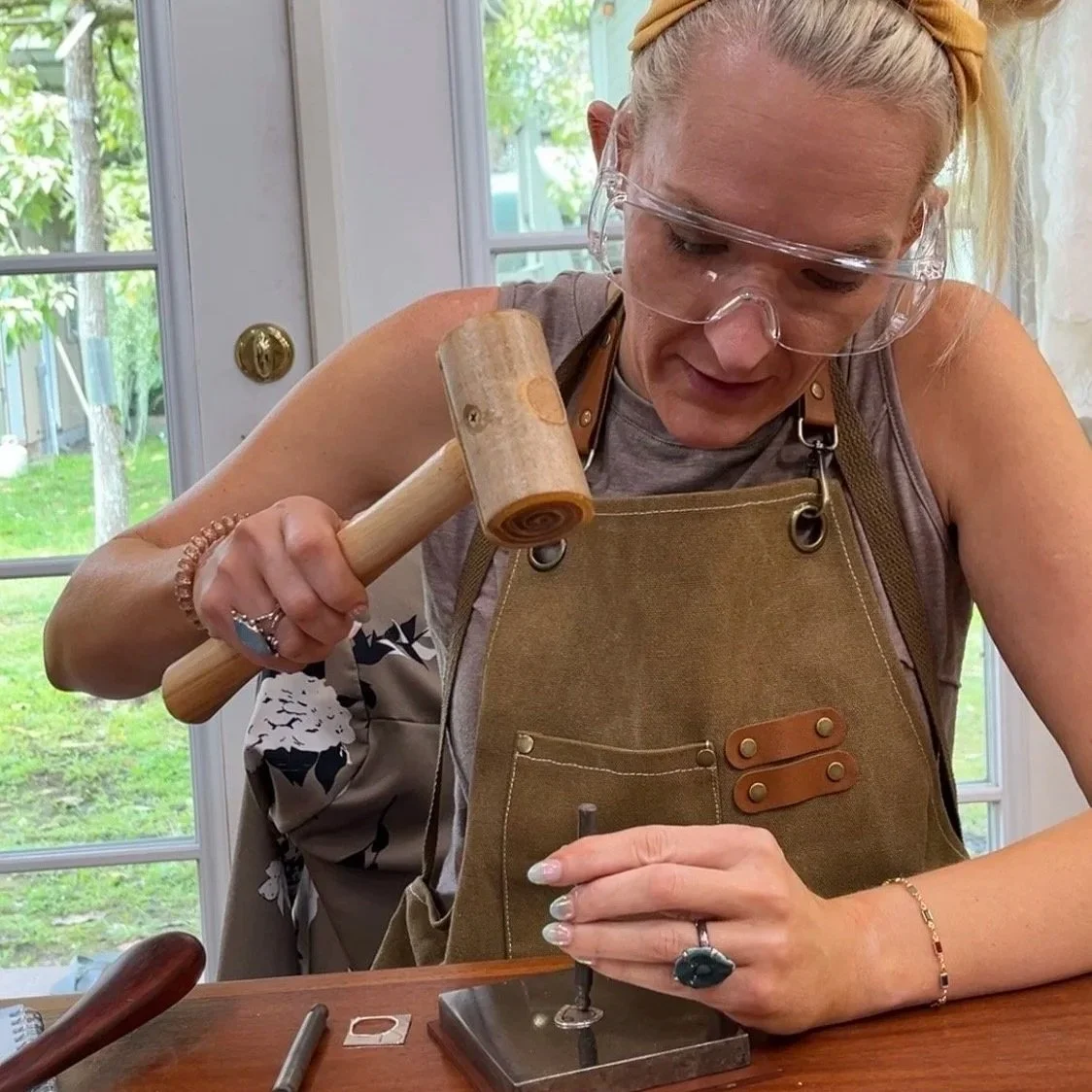 Student taking a hands-on jewelry making class near Hilo, Hawaii in a silversmith studio on the Big Island