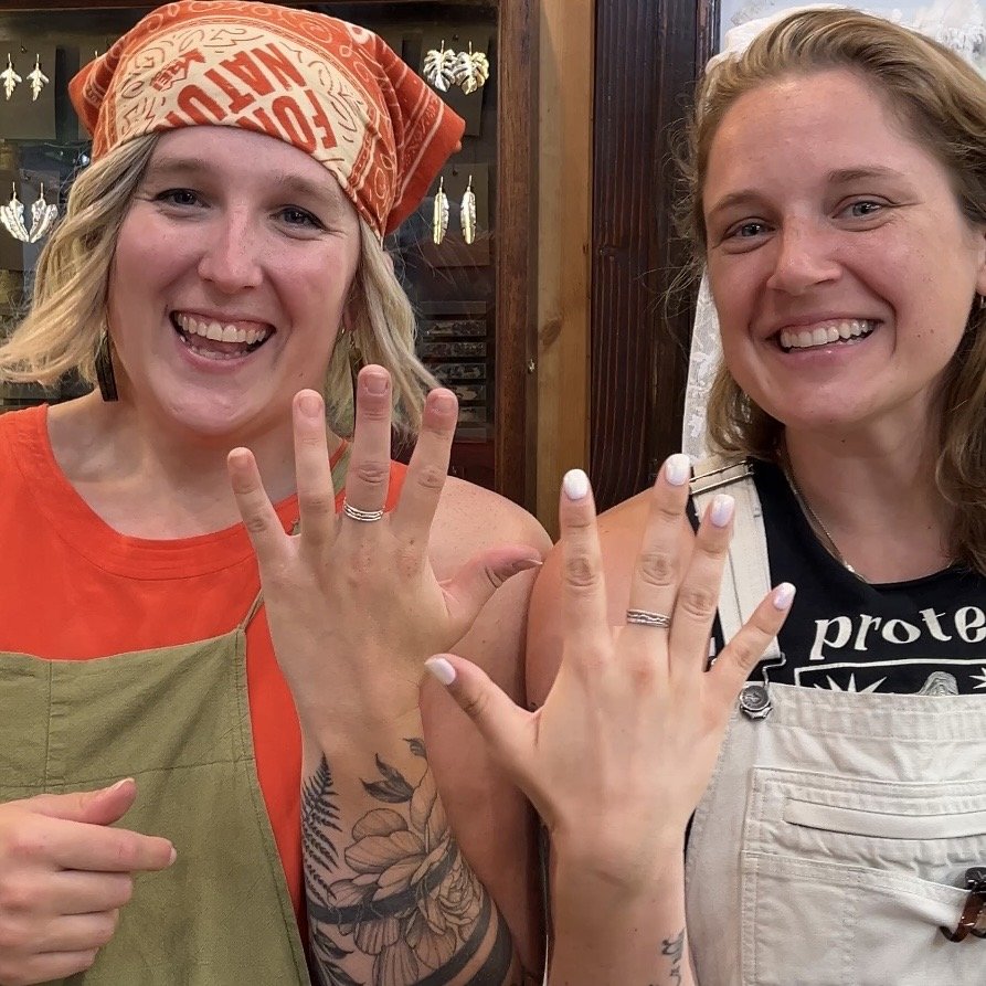 Two students proudly showing the sterling silver stacking rings they made during a jewelry workshop on the Big Island of Hawaiʻi.
