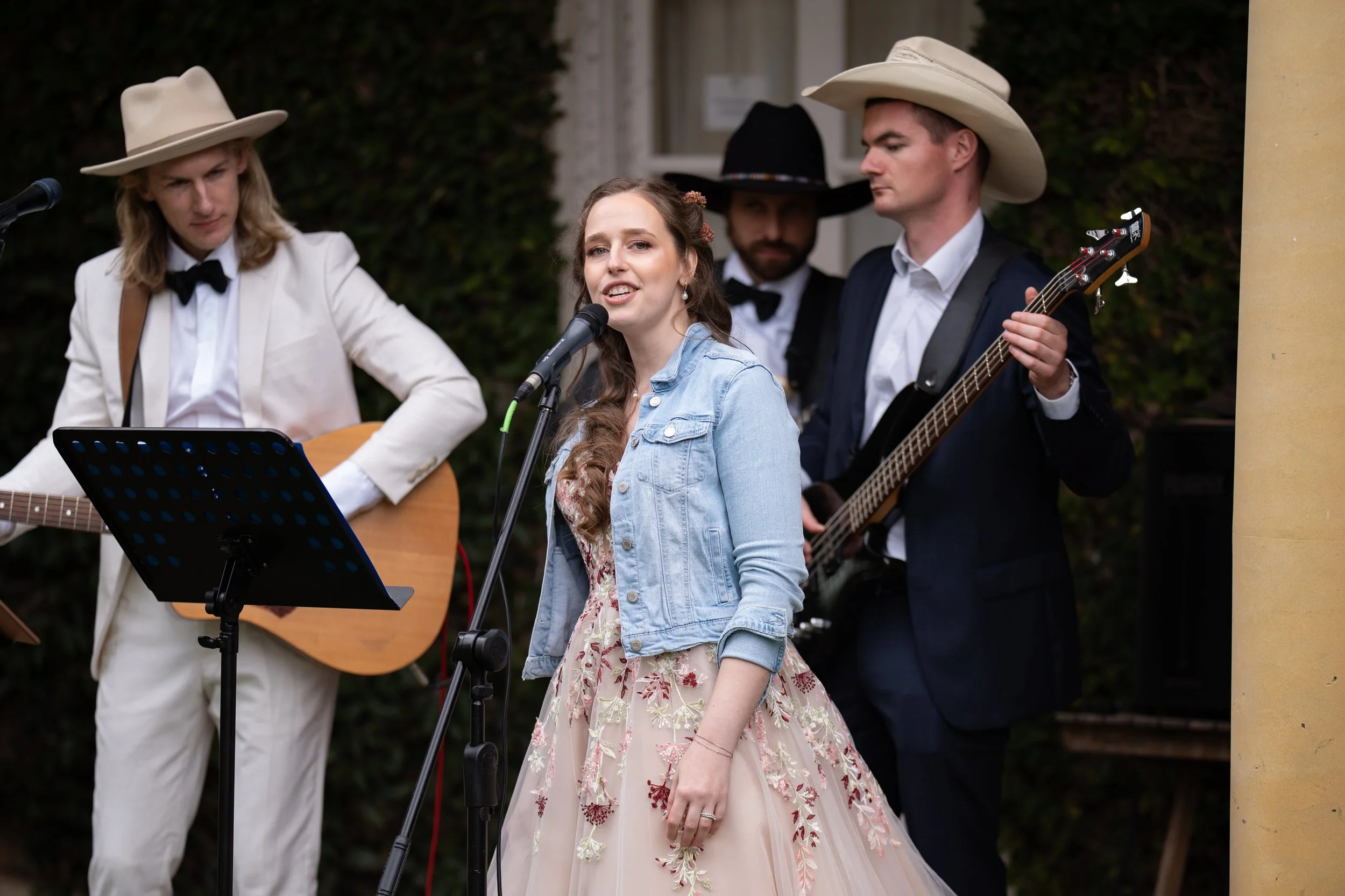 Bride performing with the live wedding band during cocktail hour at an Adelaide Hills wedding reception.