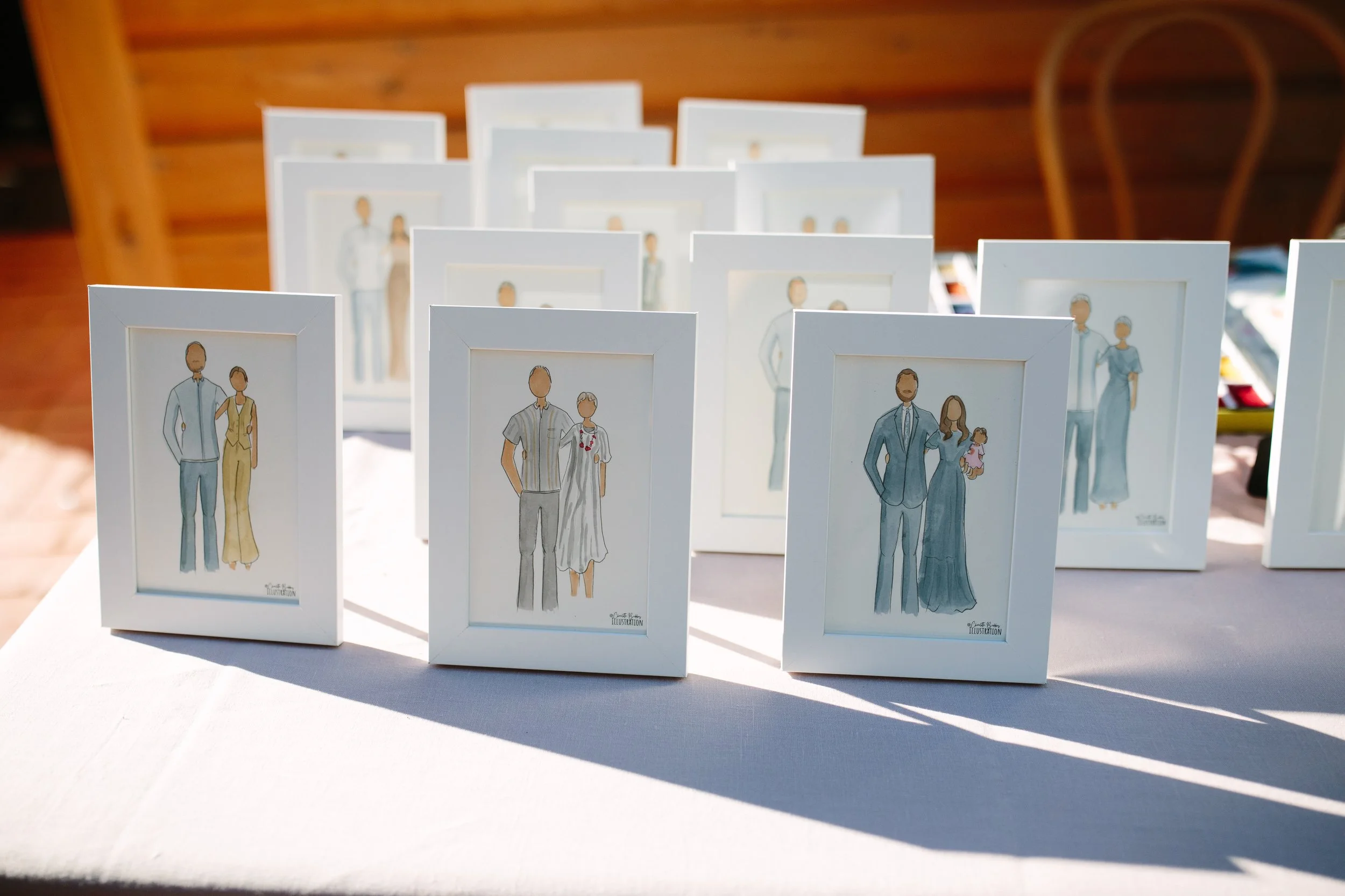 Wedding guests watching a live illustrator create personalised watercolour portraits during pre-dinner drinks at an intimate Marybank Estate wedding.