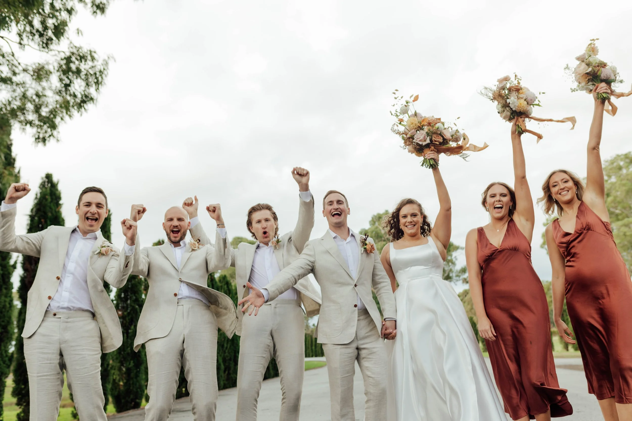 Joyful wedding party celebrating after the ceremony at a beautifully organised event through wedding planning Adelaide services