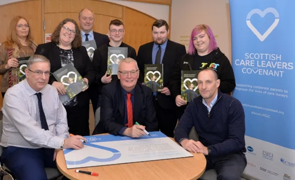 Pictured: Council Leader Jim Logue and Councillor Willie Goldie sign the Covenant with Kenny McGhee from the Care Leavers Alliance.