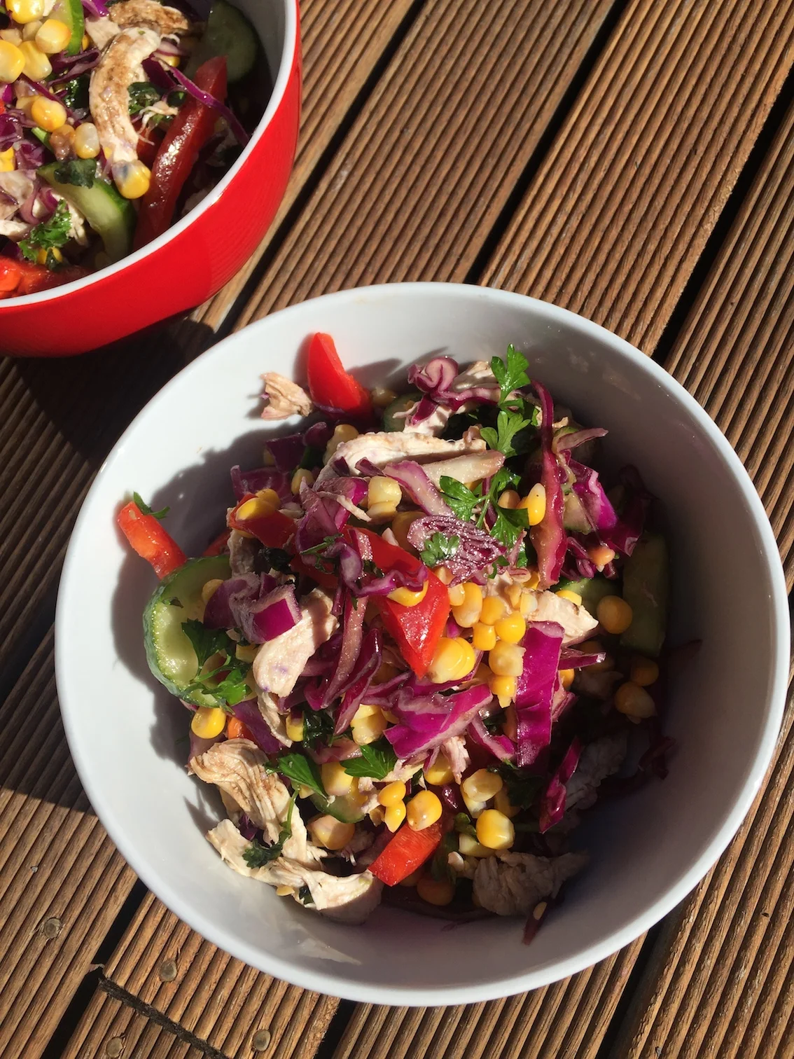 Shredded cabbage salad with poached chicken, corn and avocado