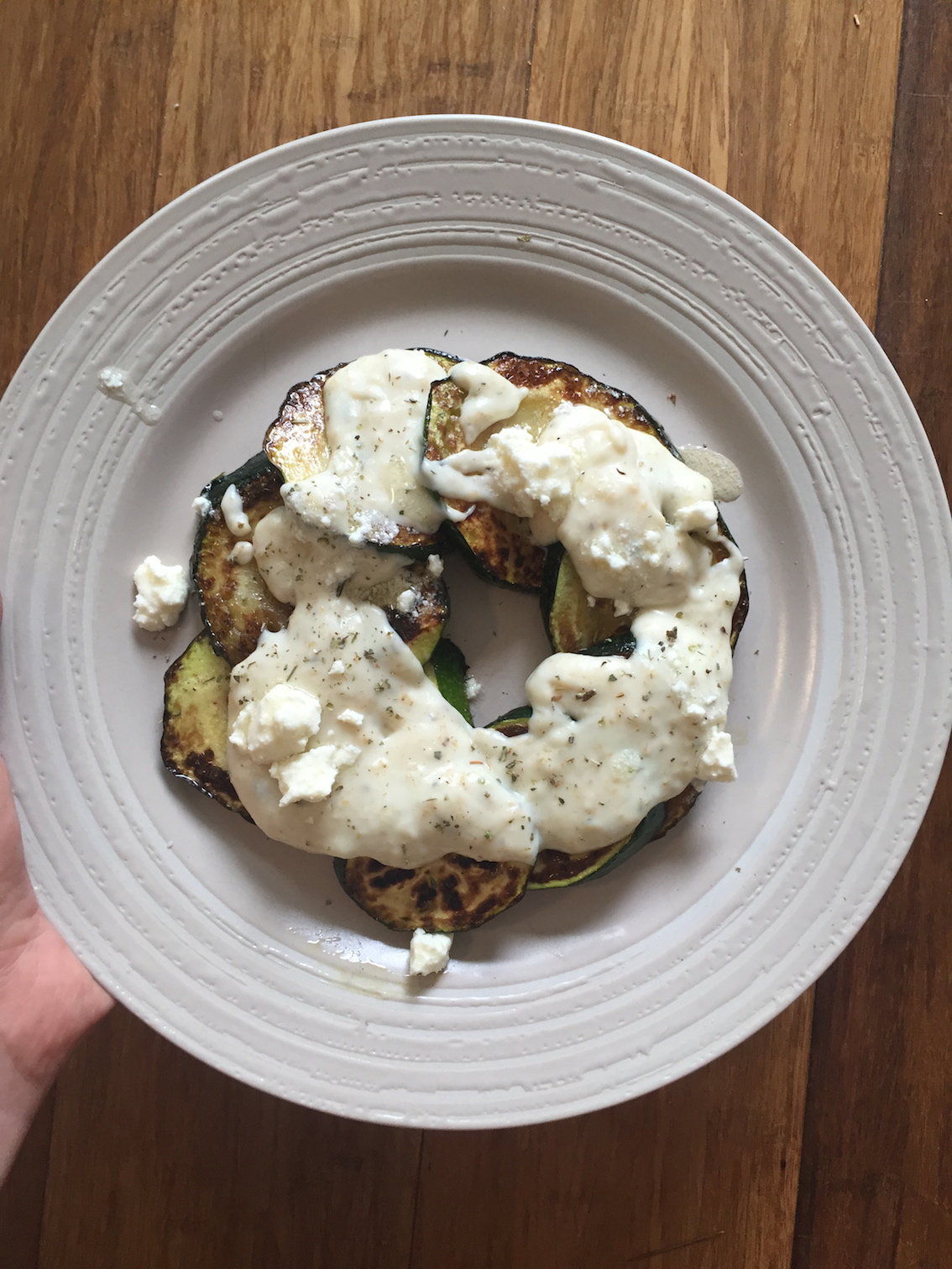Grilled zucchini with white sauce, using wholemeal flour and mixed herbs, and crumbled feta on top. Delicious.