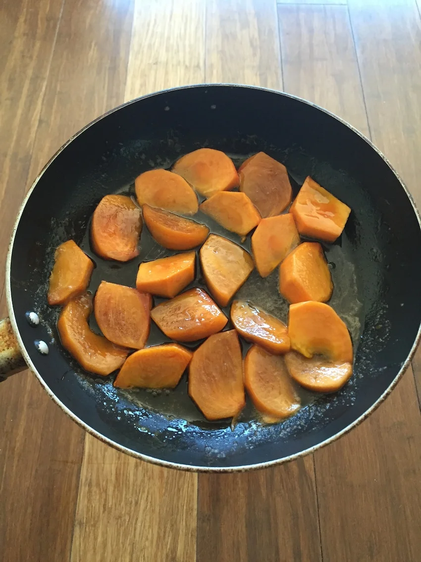 Caramelised persimmons in the fry pan. 