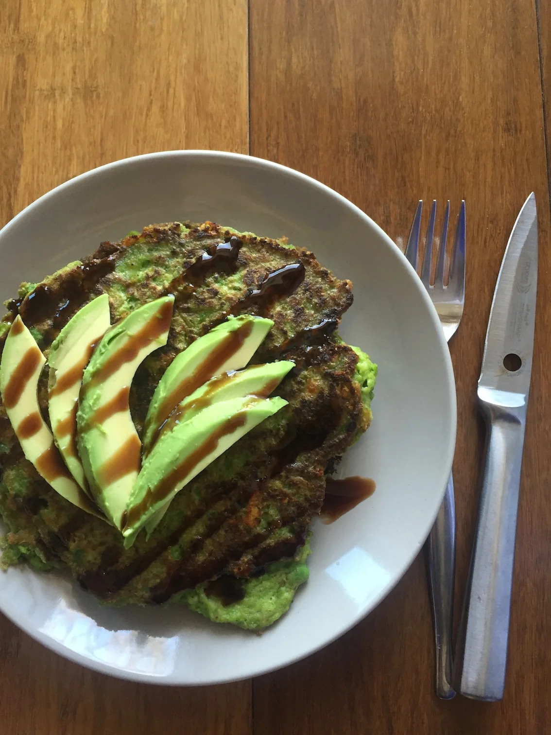 Green pea pancakes with avocado and balsamic glaze 
