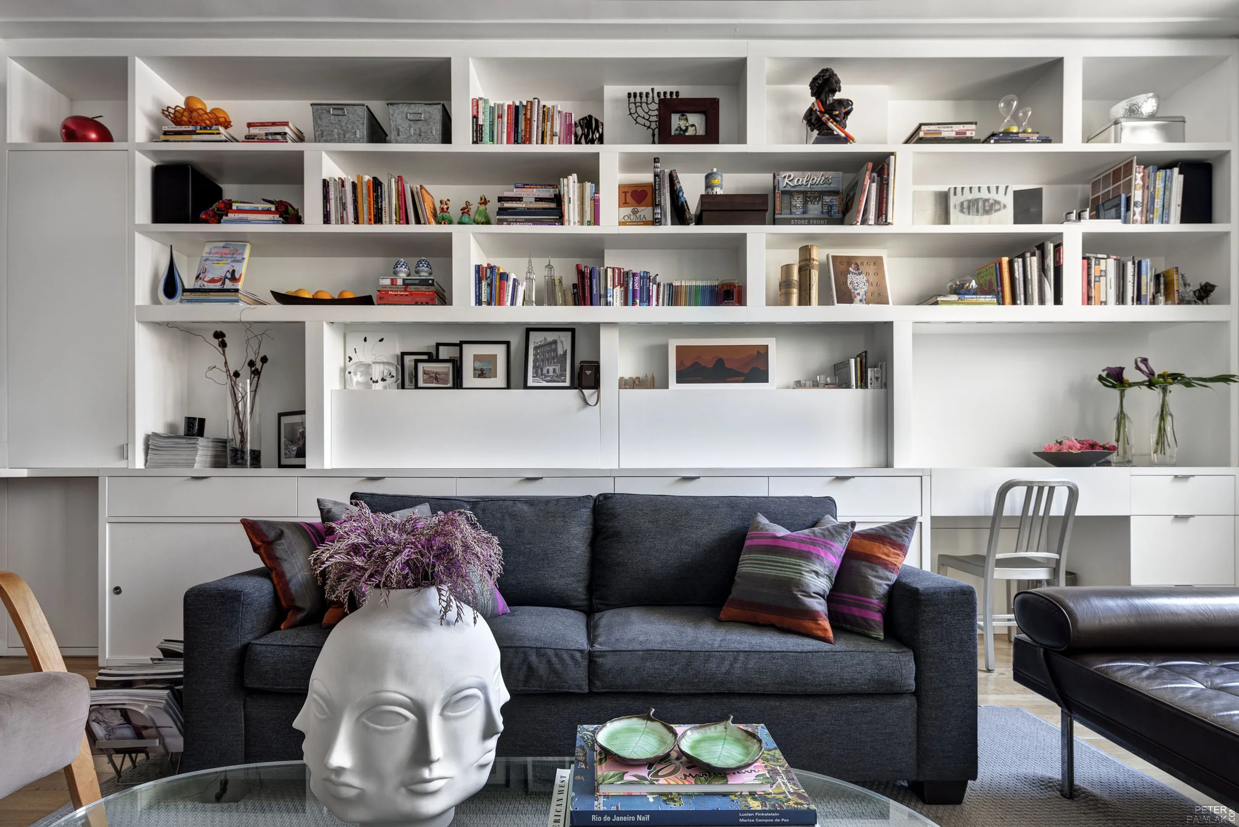   Family Room &nbsp;  Custom made wall shelving unit for the book, object display and hidden desk built on site.   Bruce Buck photographer  