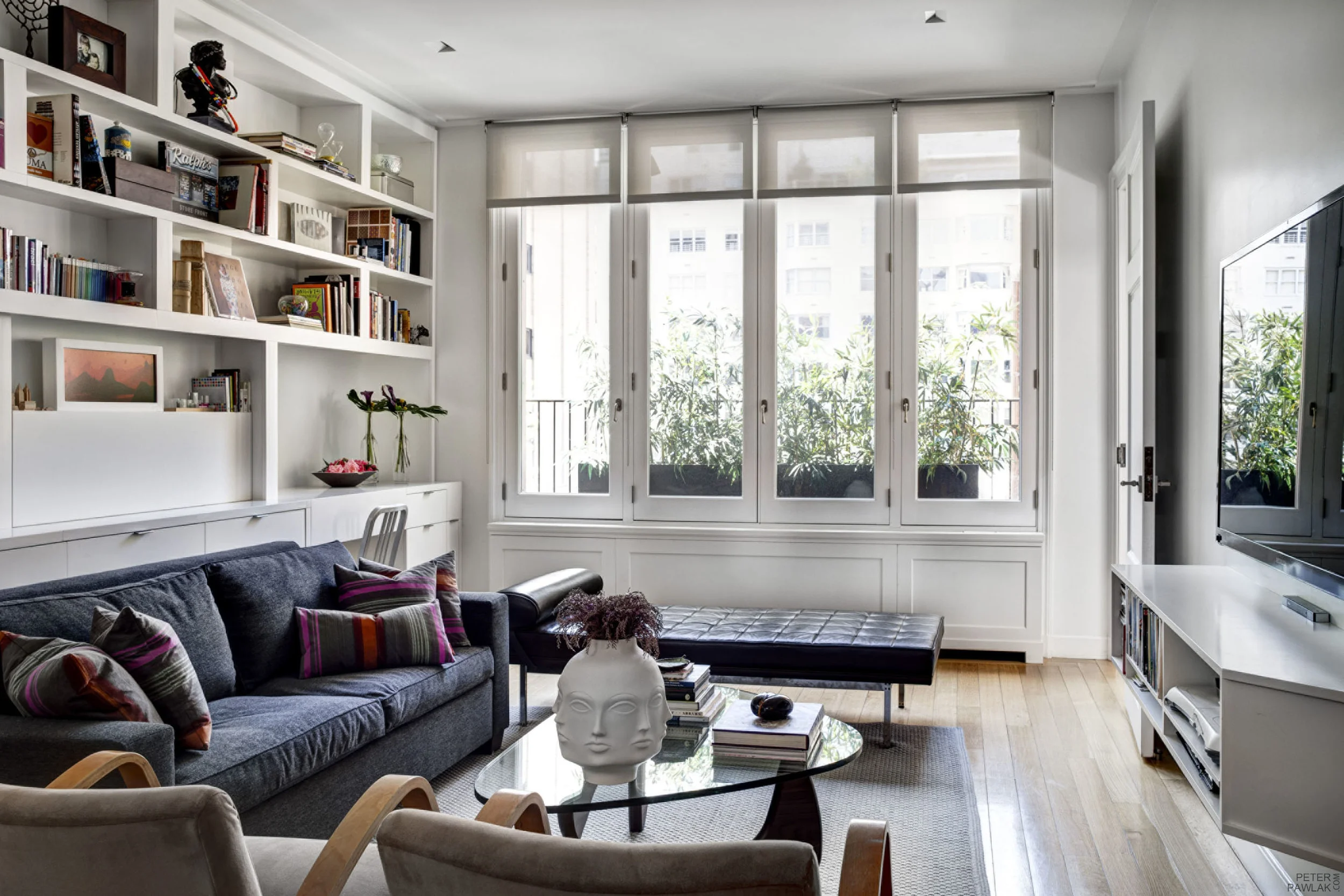   Family Room &nbsp;   This multi-function room has a library, sleepover sofa, desk with flip up top, tv and diorama outdoor space with bamboo plants visually extending interior space while illuminated at night time.    Bruce Buck photographer  