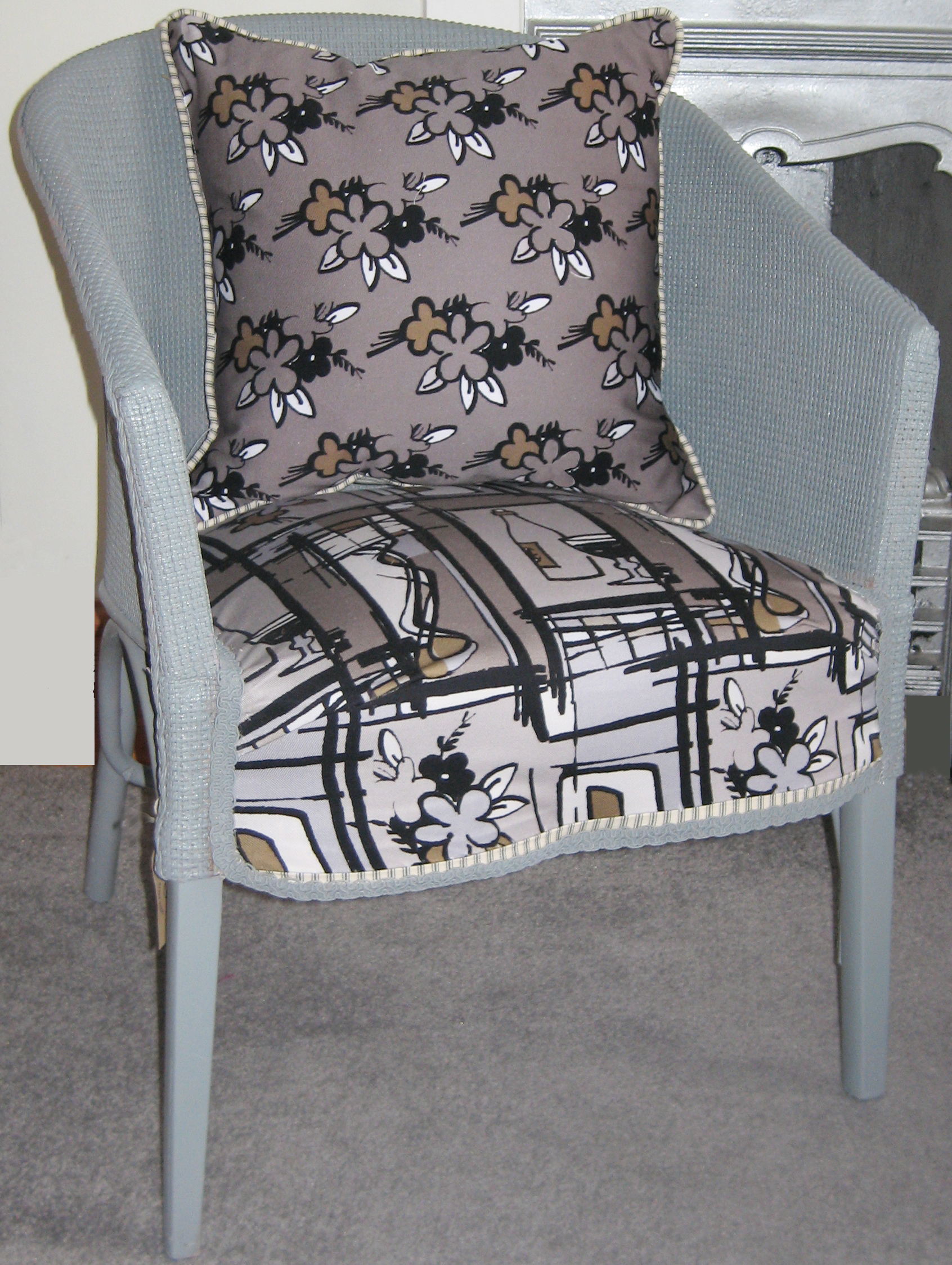 Chair covered in bottles and flowers fabrics grey