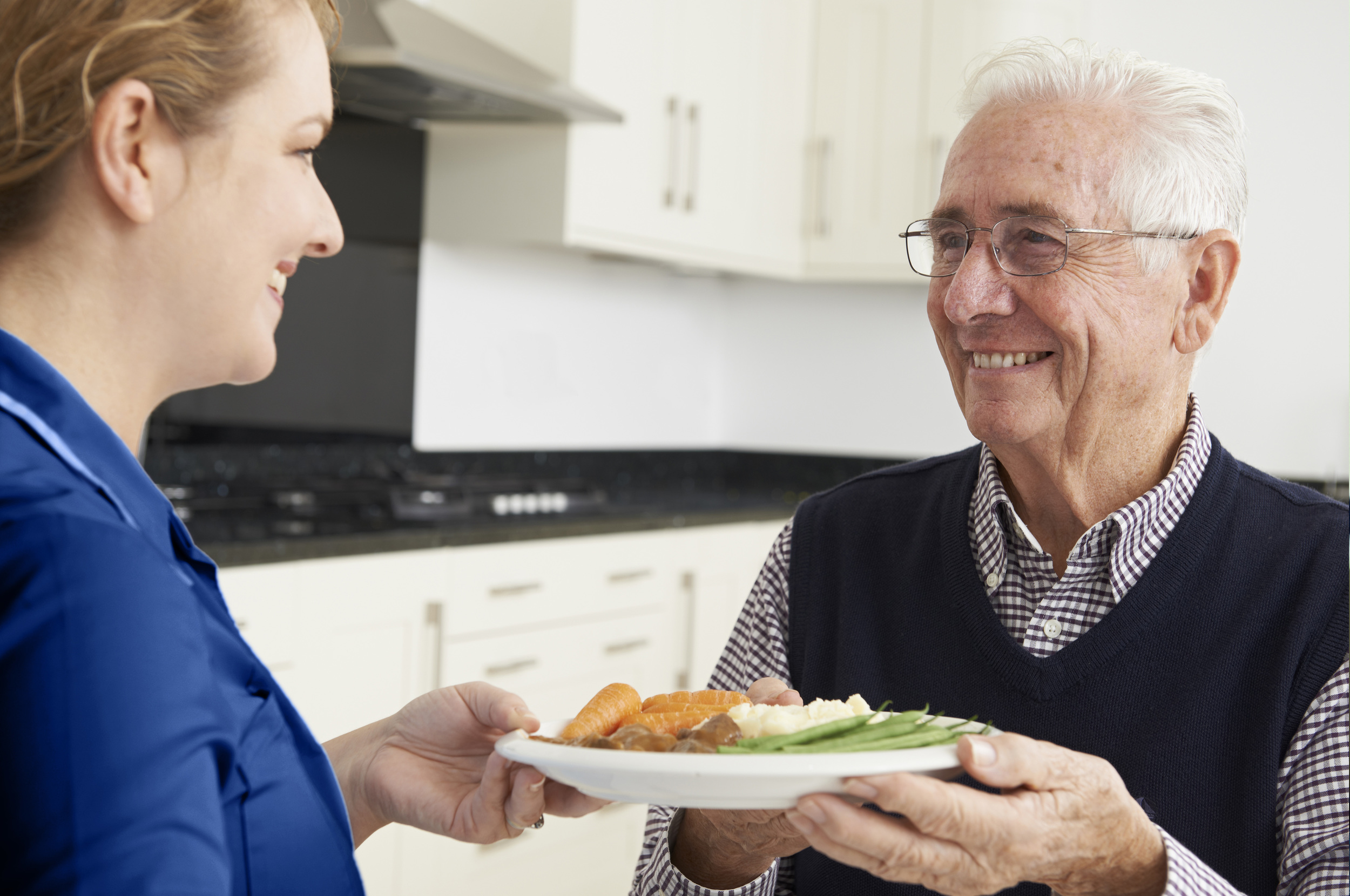 Assurance Home Care nurse helping patient cook dinner