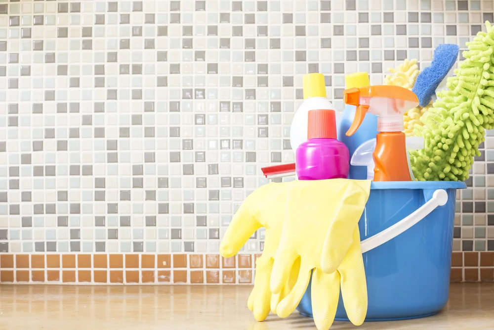 A bucket full of cleaning supplies.