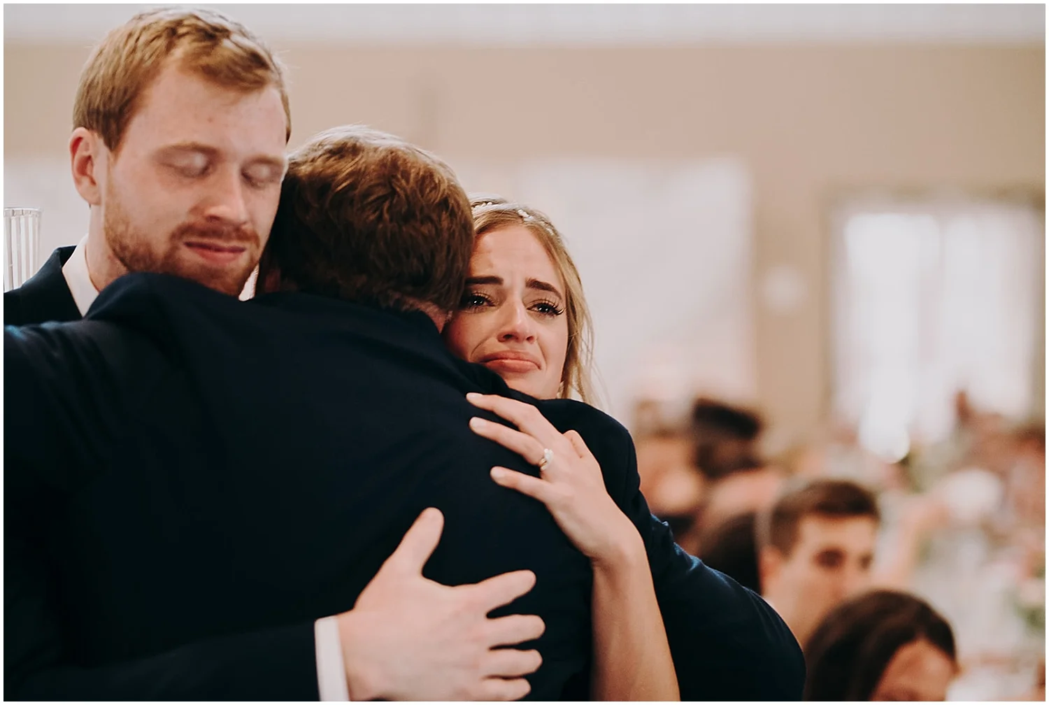 the bride and groom having an emotional hug