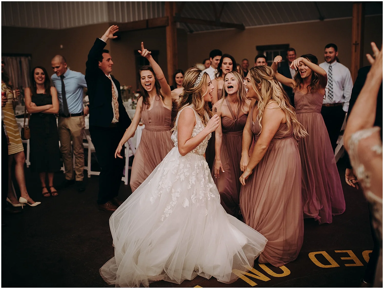 the bride and the bridesmaids dancing at the wedding reception