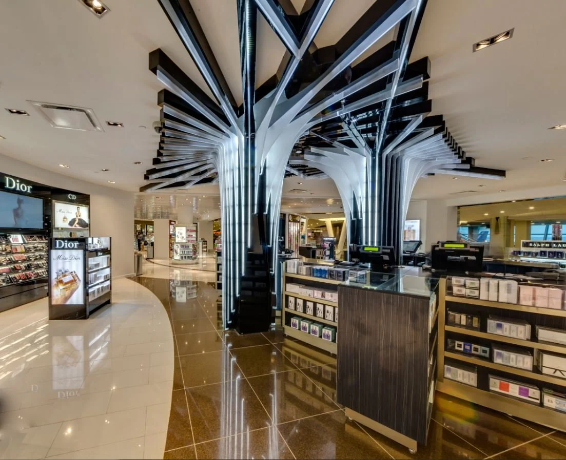 Duty-free retail interior at JFK Terminal 4 featuring illuminated sculptural columns.