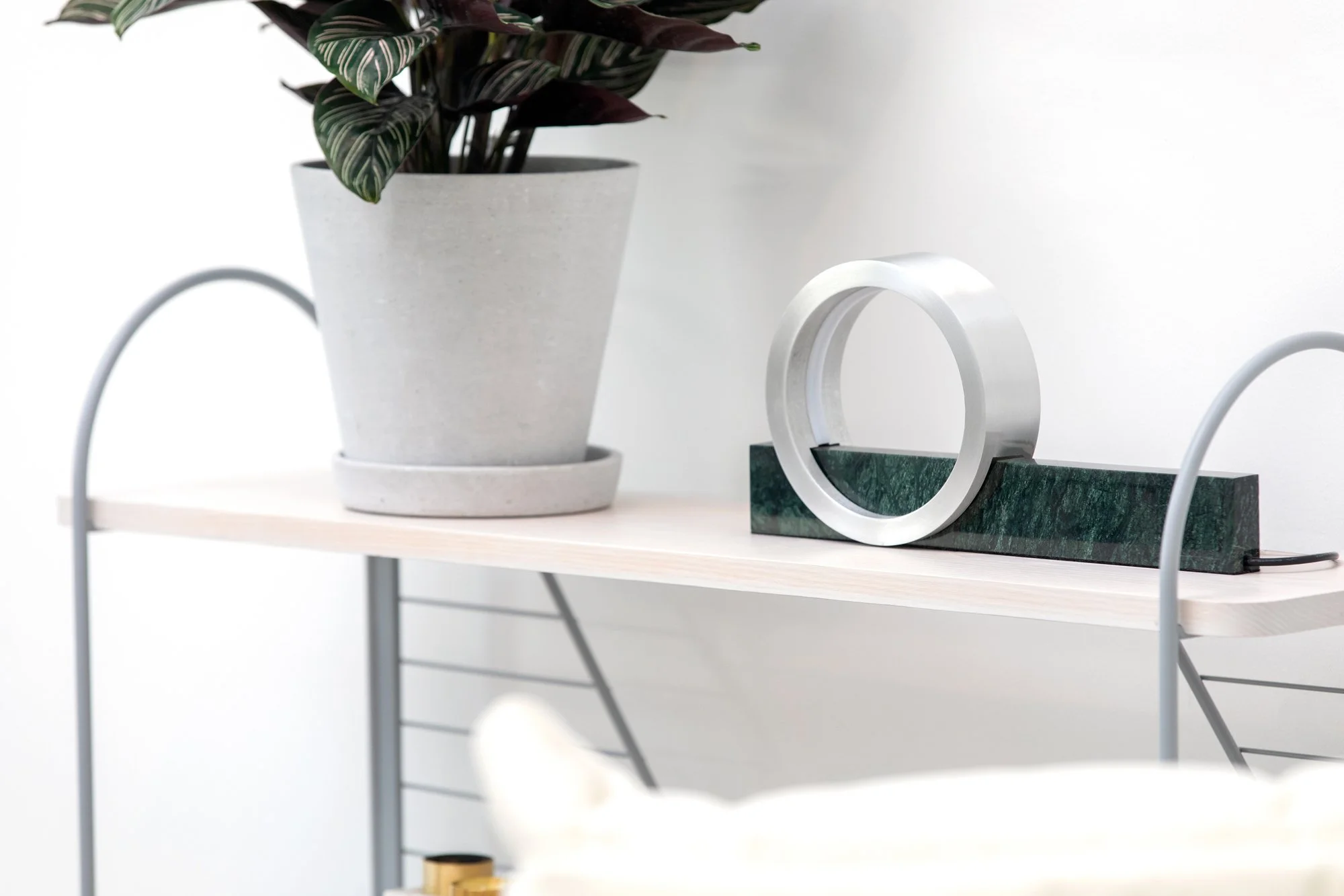 White Composition Light table lamp styled on shelf with plant and marble surface