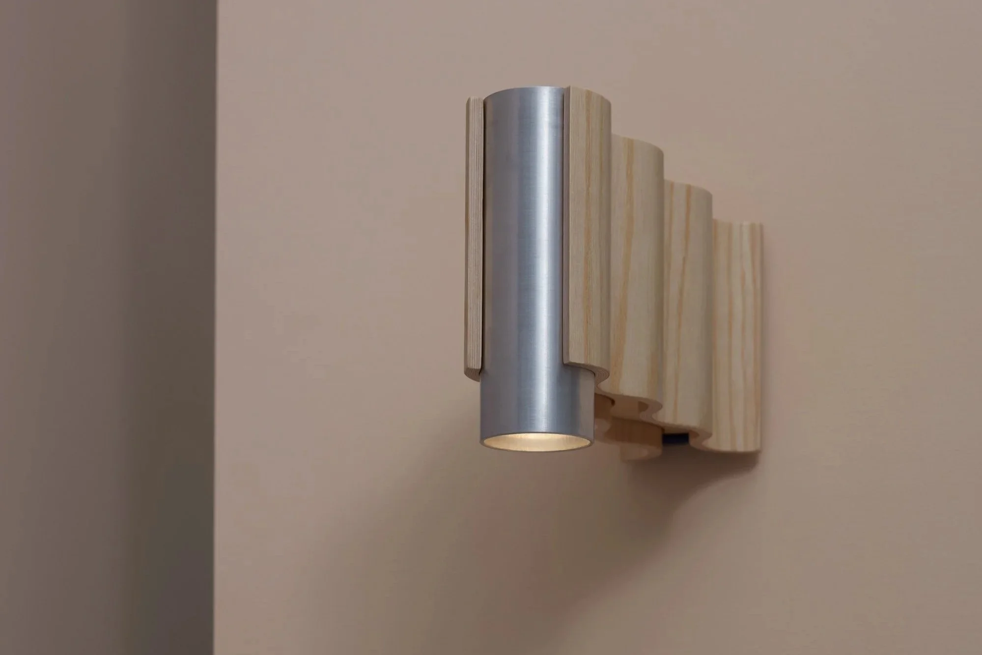 Corrugation wall sconce in natural ash veneer with brushed aluminium cylindrical fitting