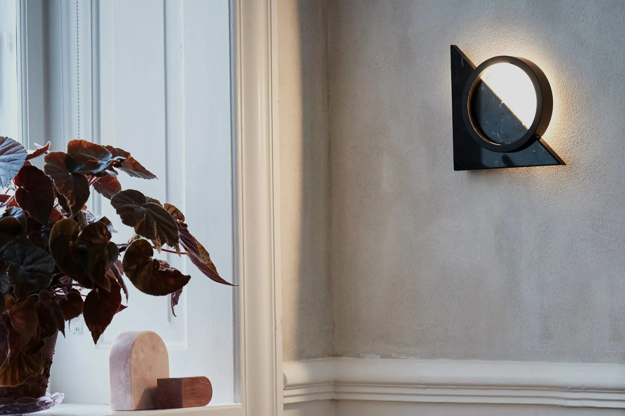 Composition Light wall lamp styled in interior above chair and shelf