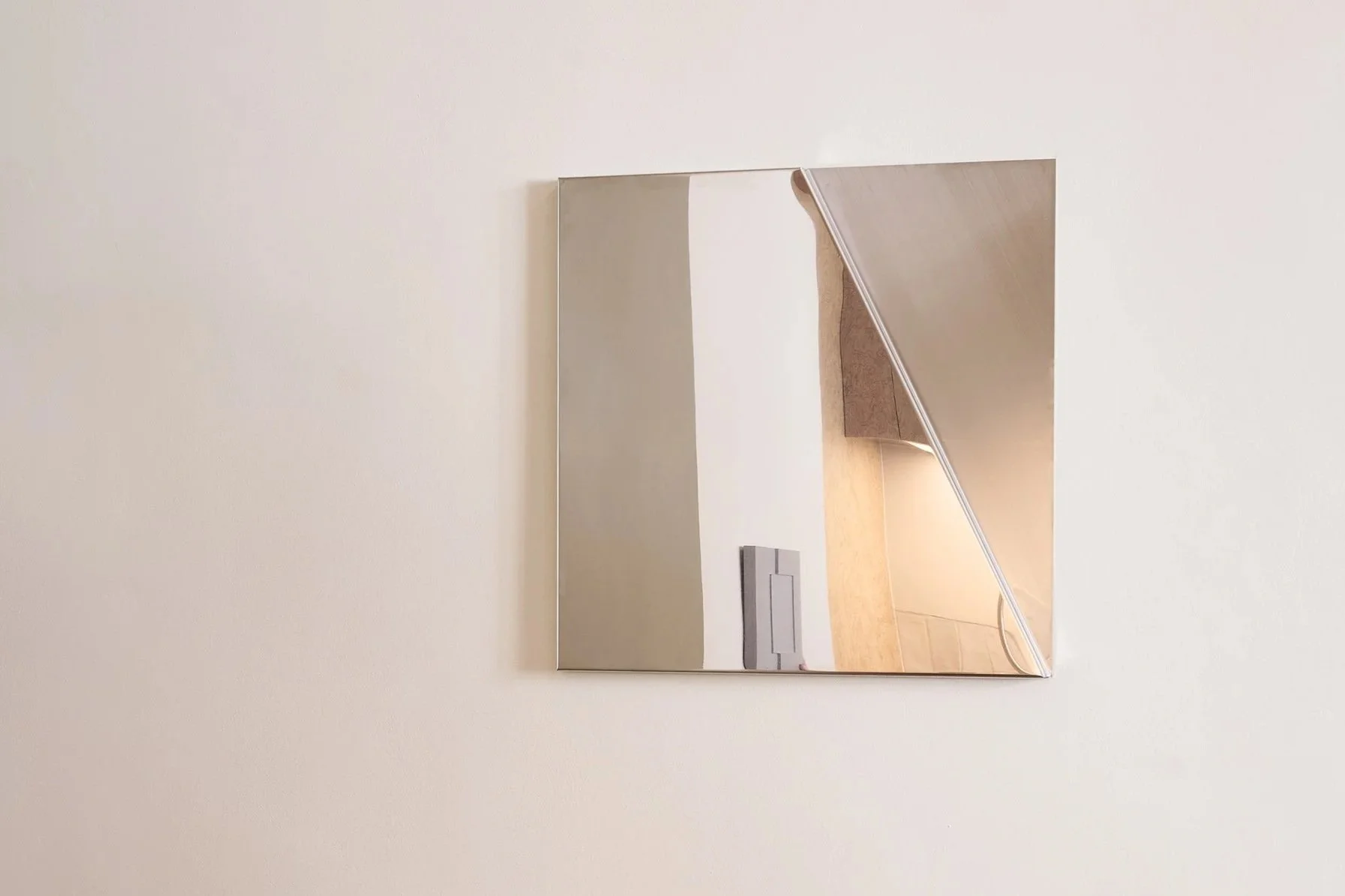 Contemporary geometric wall mirror made from folded metal