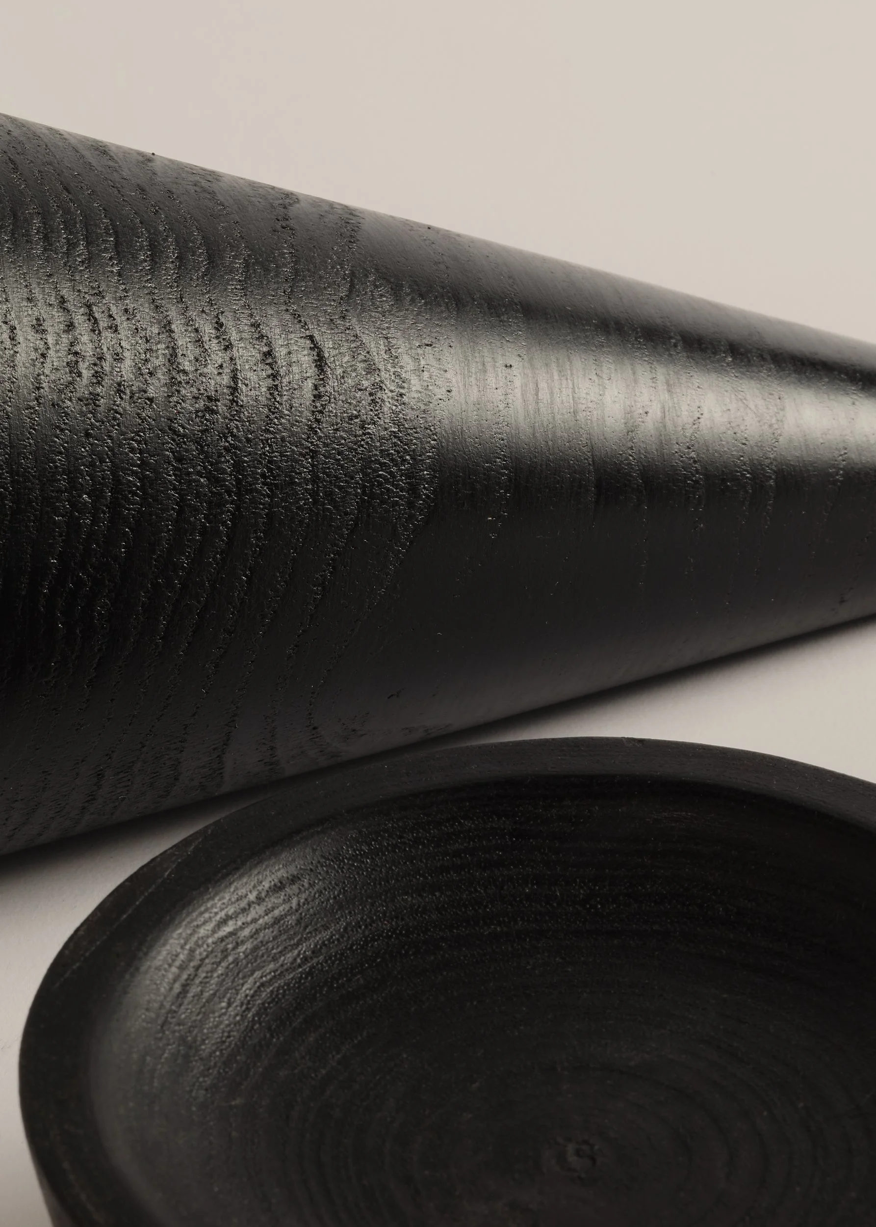 Close-up detail of Keilir pestle and mortar showing turned black wood grain and matte finish