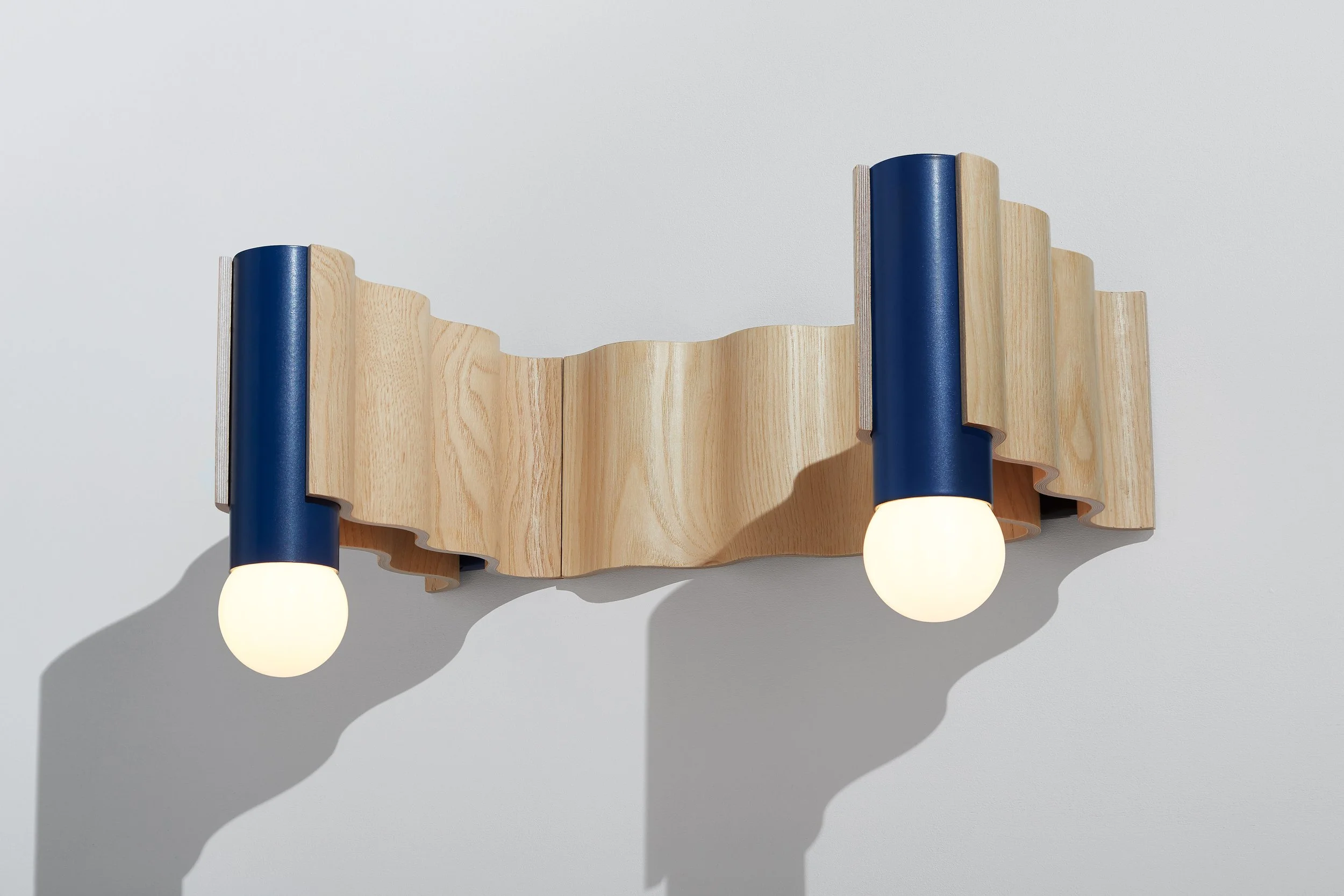 Corrugation modular wall light in ash veneer with blue aluminium fittings