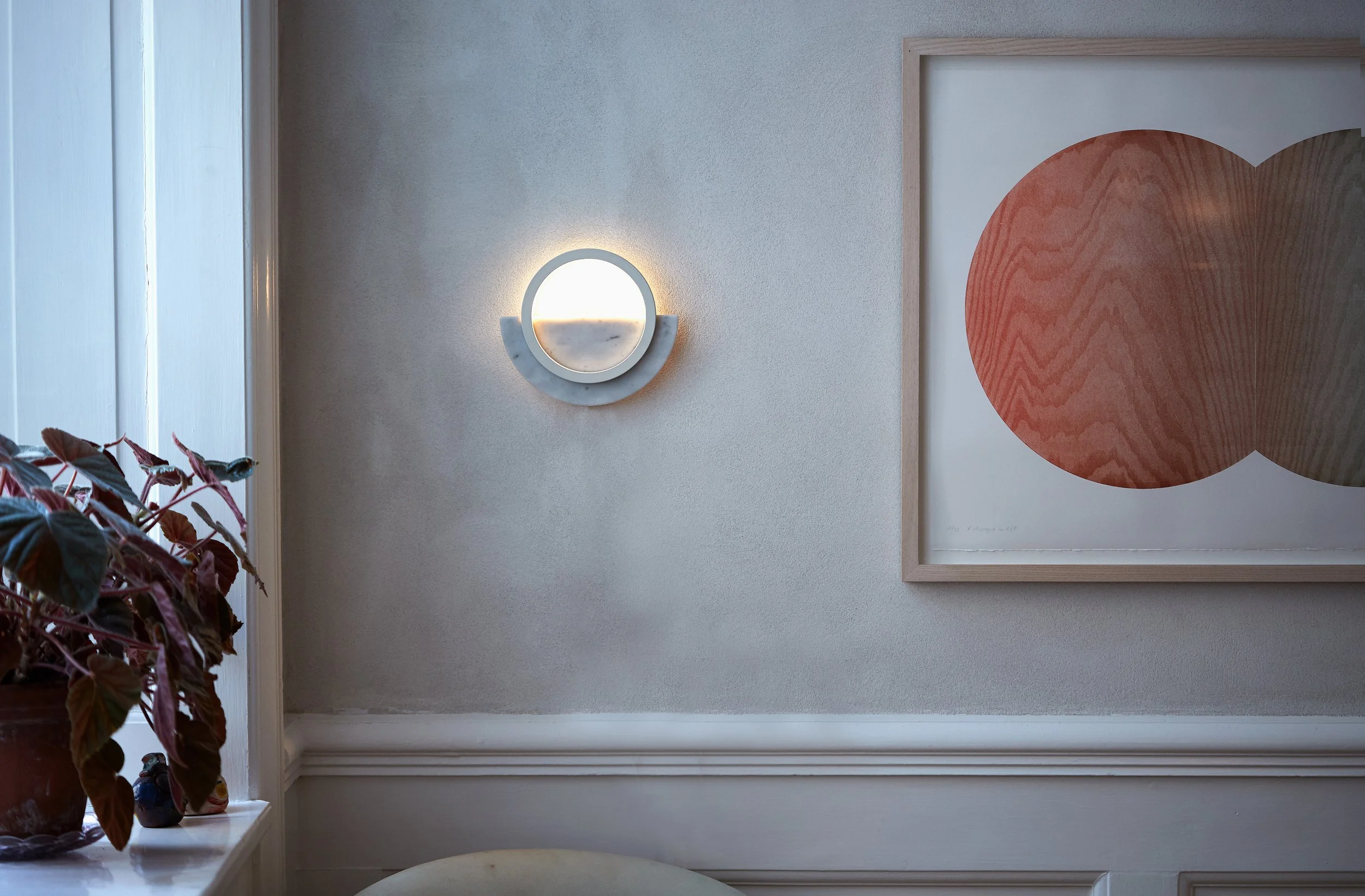 Composition Light wall lamp illuminated against textured interior wall