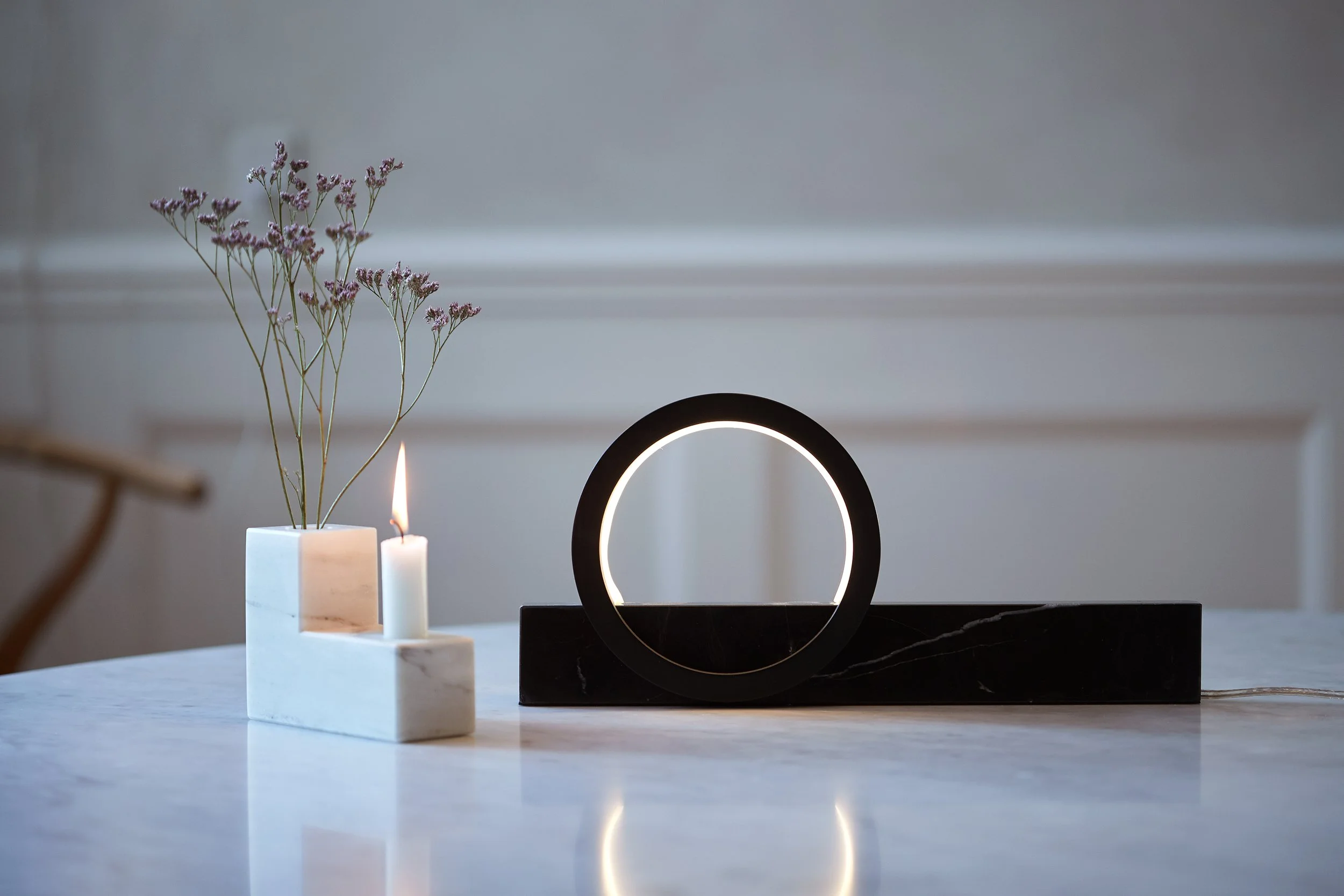 Composition Light table lamp in black marble and aluminium displayed on tabletop