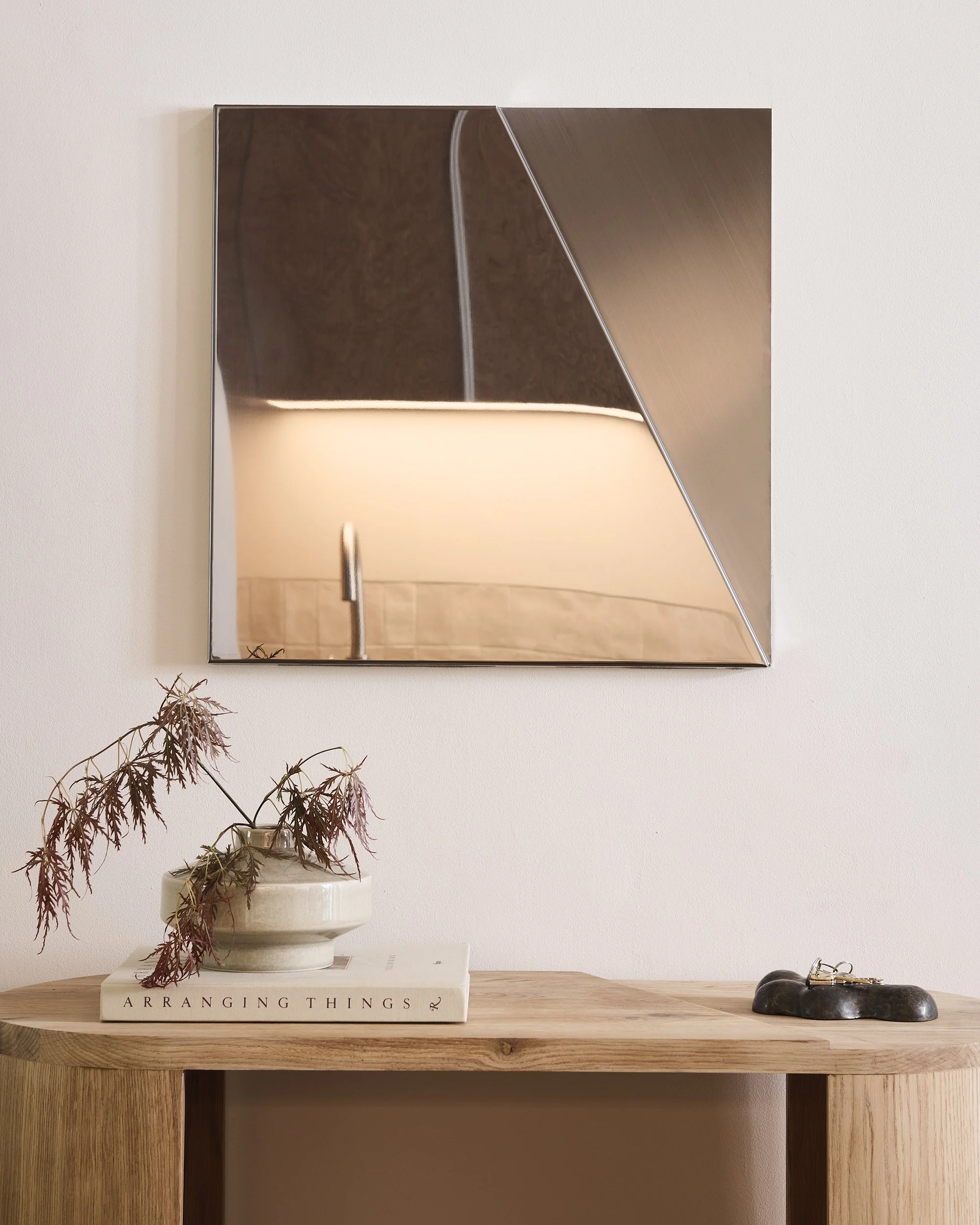 Contemporary geometric wall mirror made from folded metal