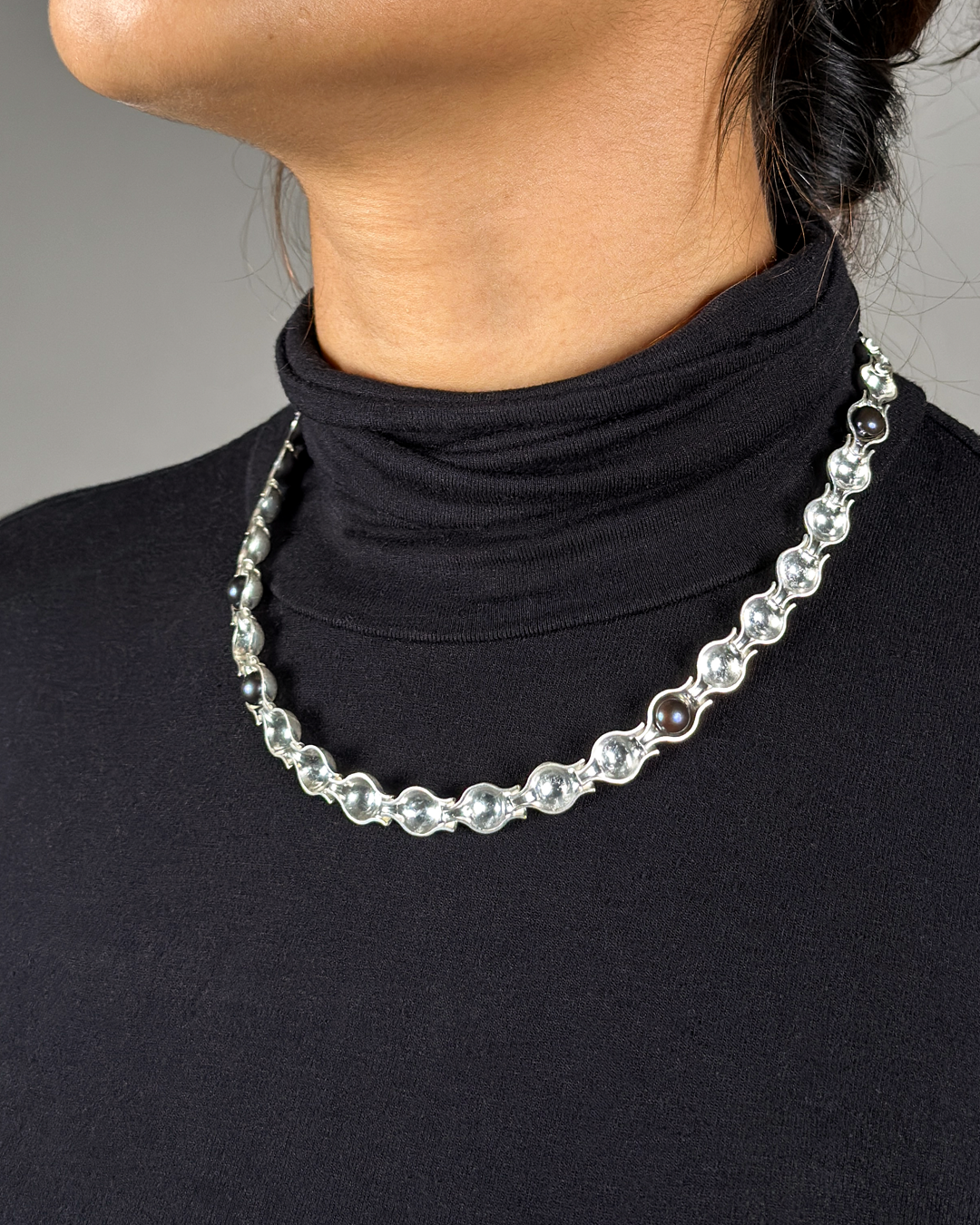 Designed for Birmingham-based jewellery brand 0.25, PERLA reimagines the traditional pearl necklace by removing the pearls from its expected form and allowing their absence to shape the design.

Crafted in recycled silver and freshwater pearls, the c
