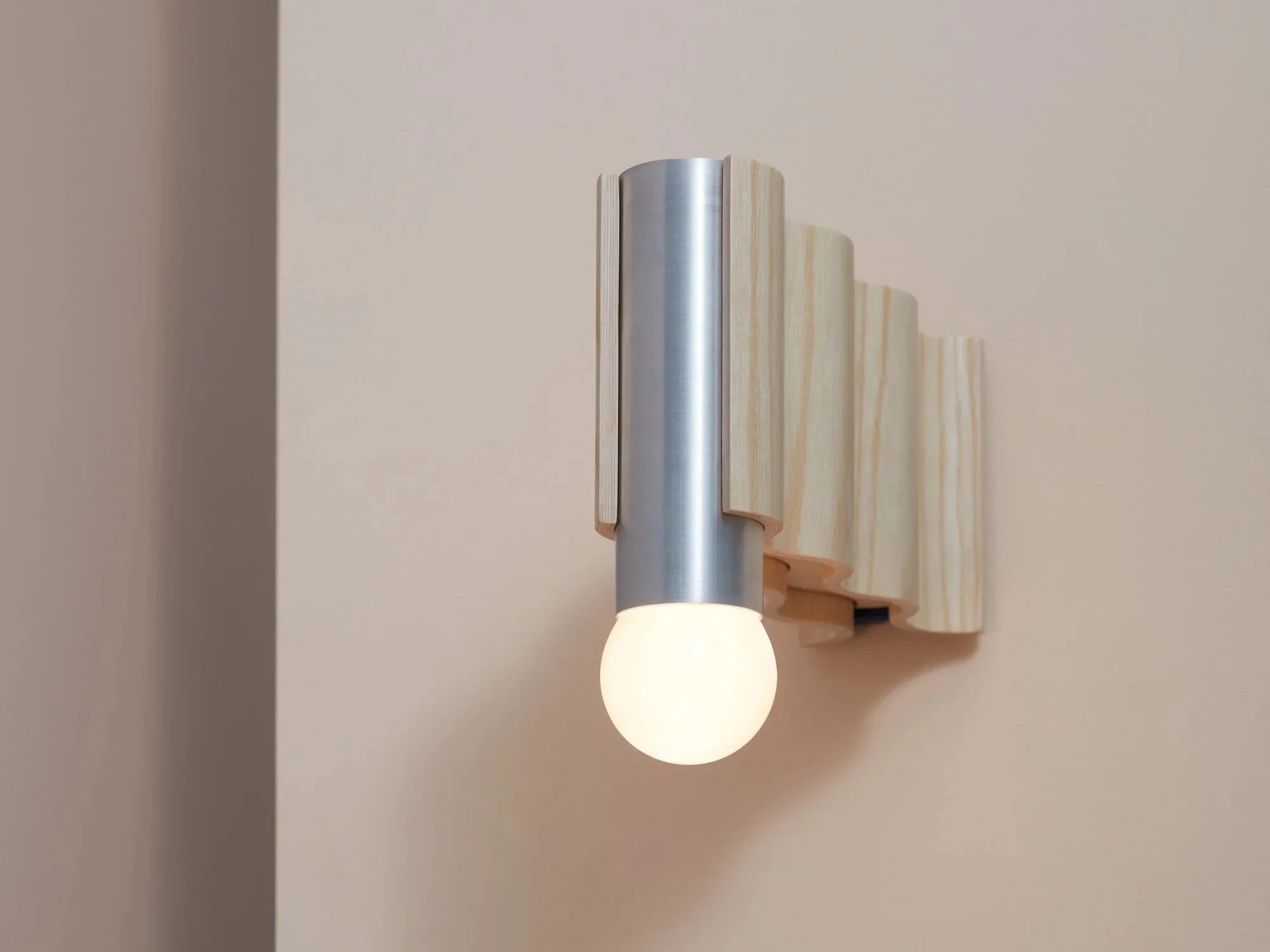 Corrugation wall sconce in natural ash veneer with brushed aluminium cylindrical fitting